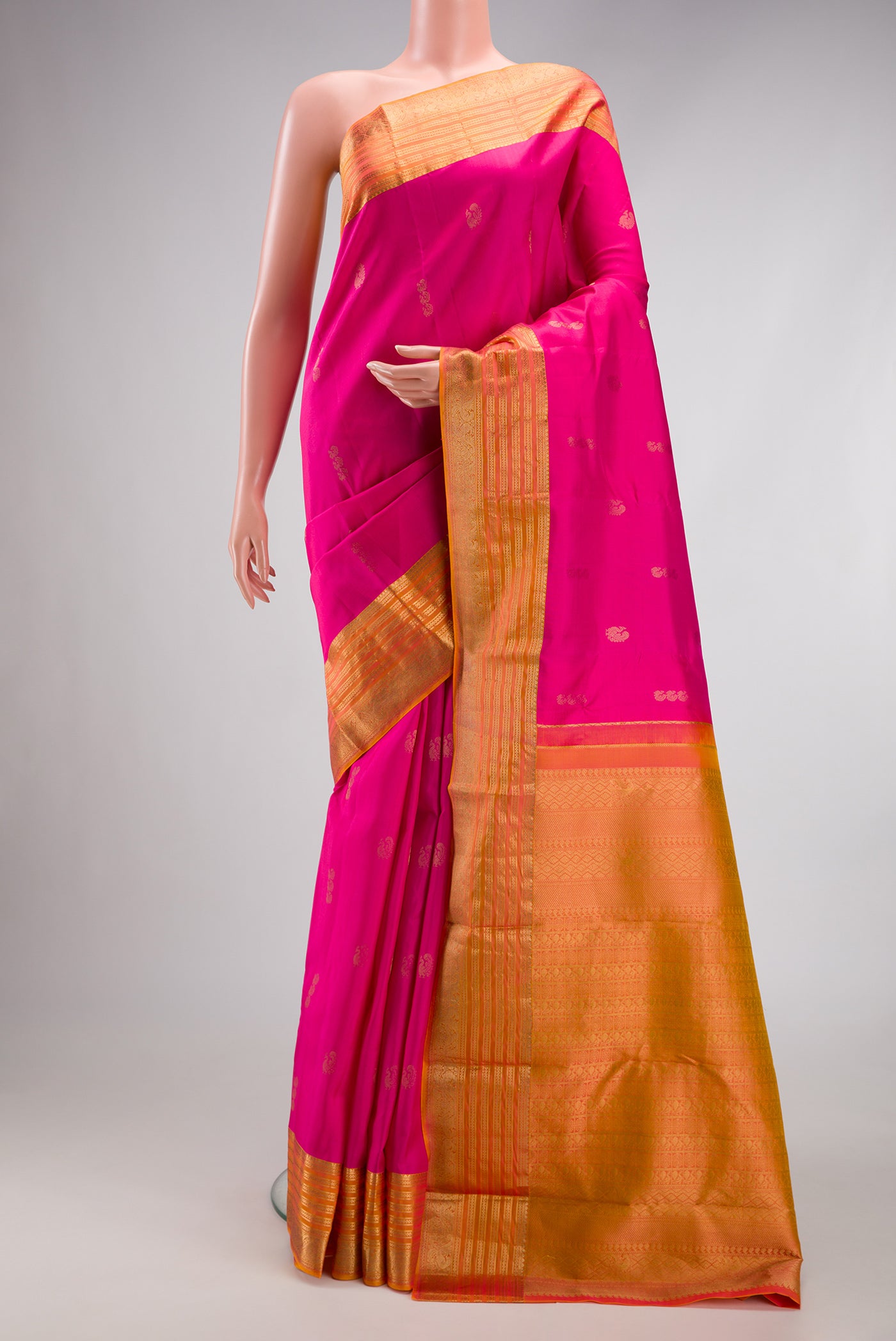 Pink Kanchipuram Silk Saree with Zari Butta on the body and Zari Border.  displayed on a mannequin