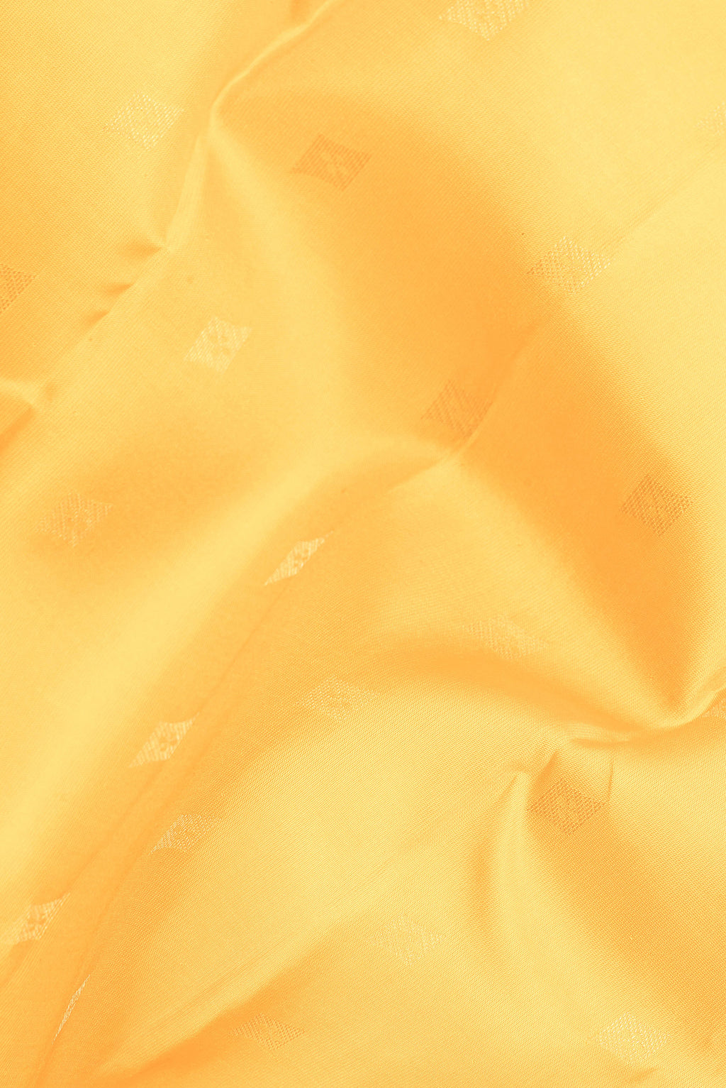 Close up of Pure Silk Yellow Kanchipuram Saree with Zari Butta on the body and Zari Border.  displaying folds