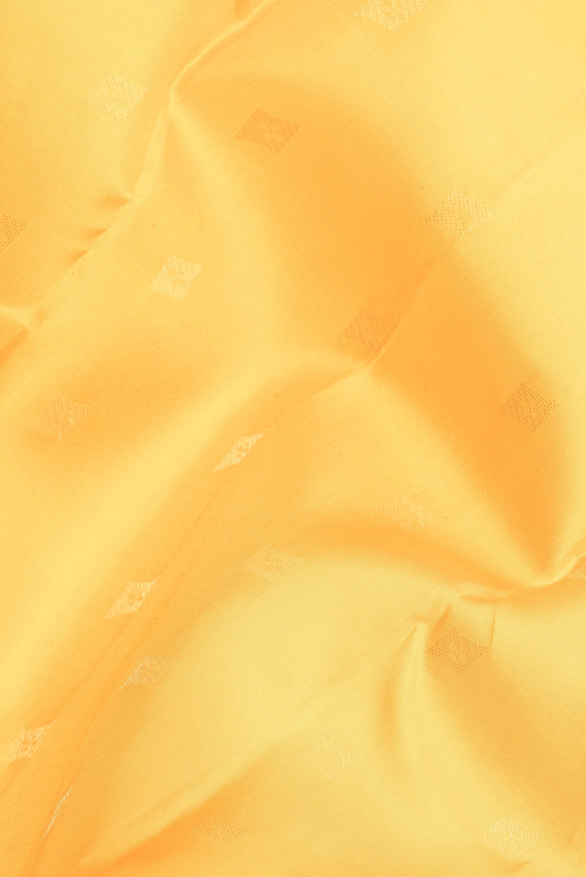 Close up of Pure Silk Yellow Kanchipuram Saree with Zari Butta on the body and Zari Border.  displaying folds