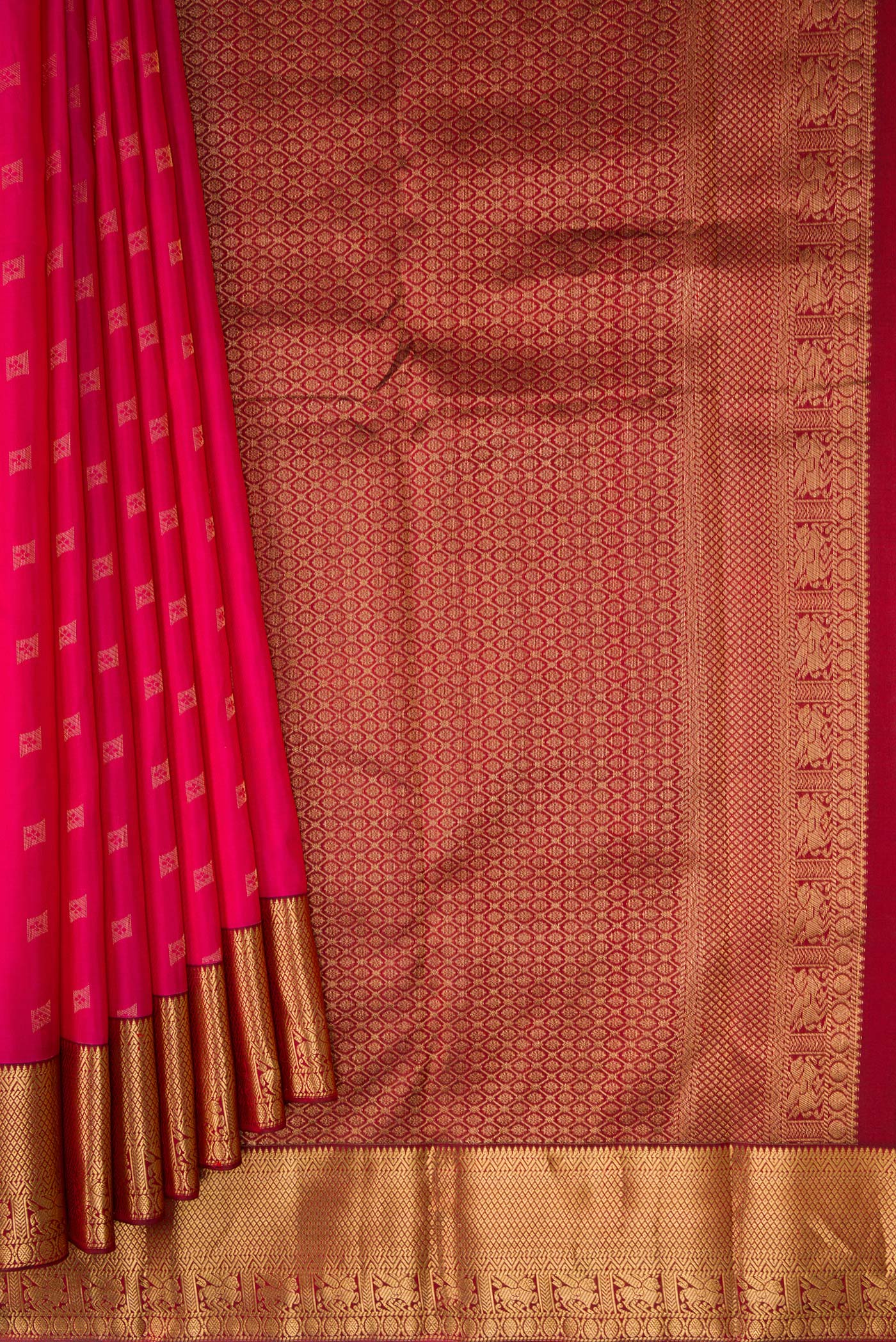 Pleats and pallu of Dark Pink Kanchipuram Silk Saree with Zari Butta on the body and Zari Border. 