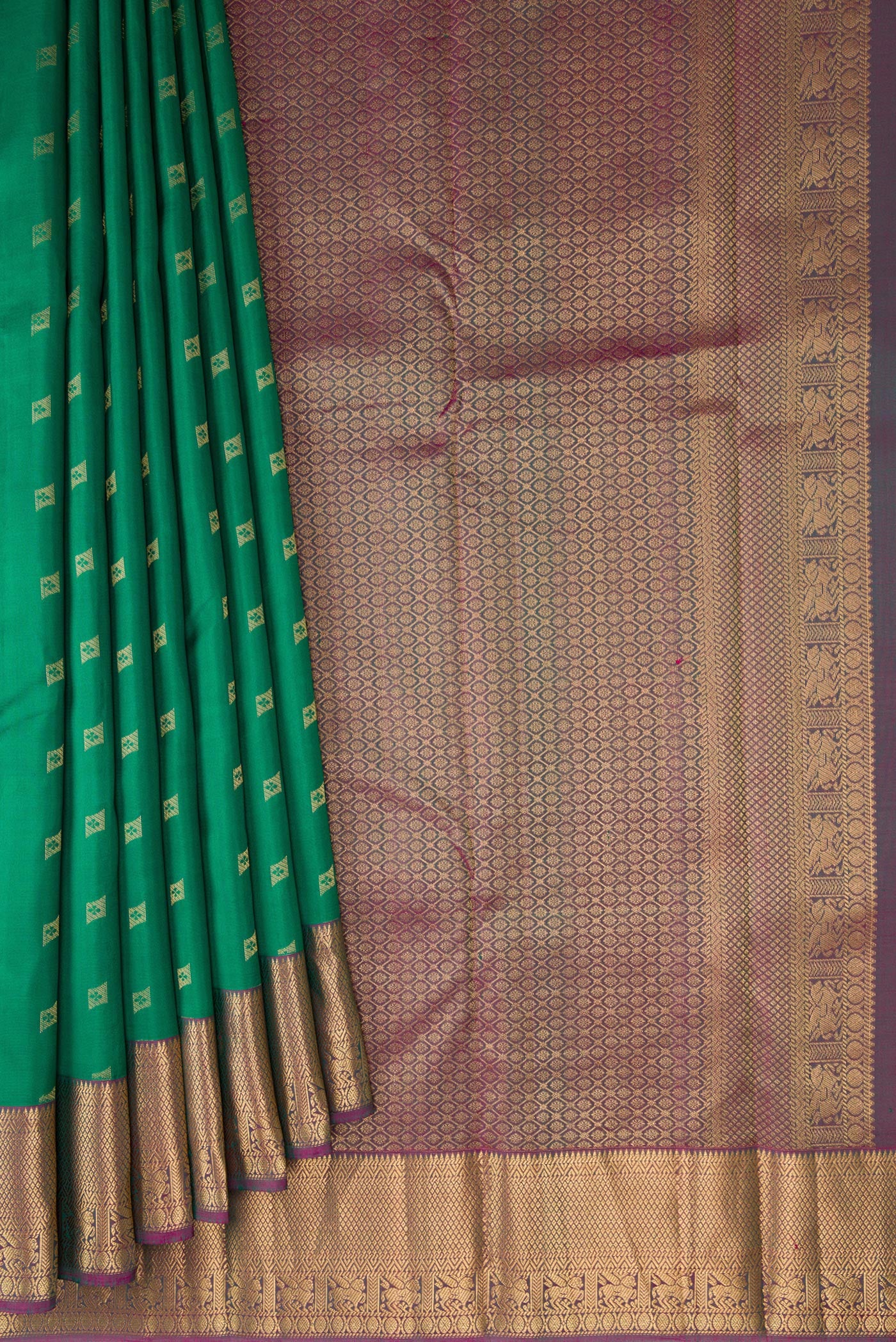 Pleats and pallu of Green Kanchipuram Silk Saree with Zari Butta on the body and Zari Border. 