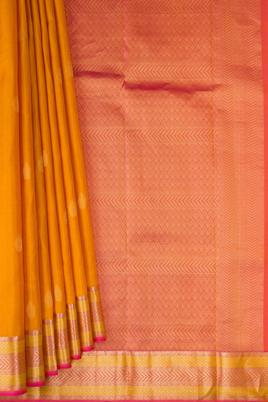 Pleats and pallu of Mustard Kanchipuram Silk Saree with Zari Butta on the body and Zari Border. 