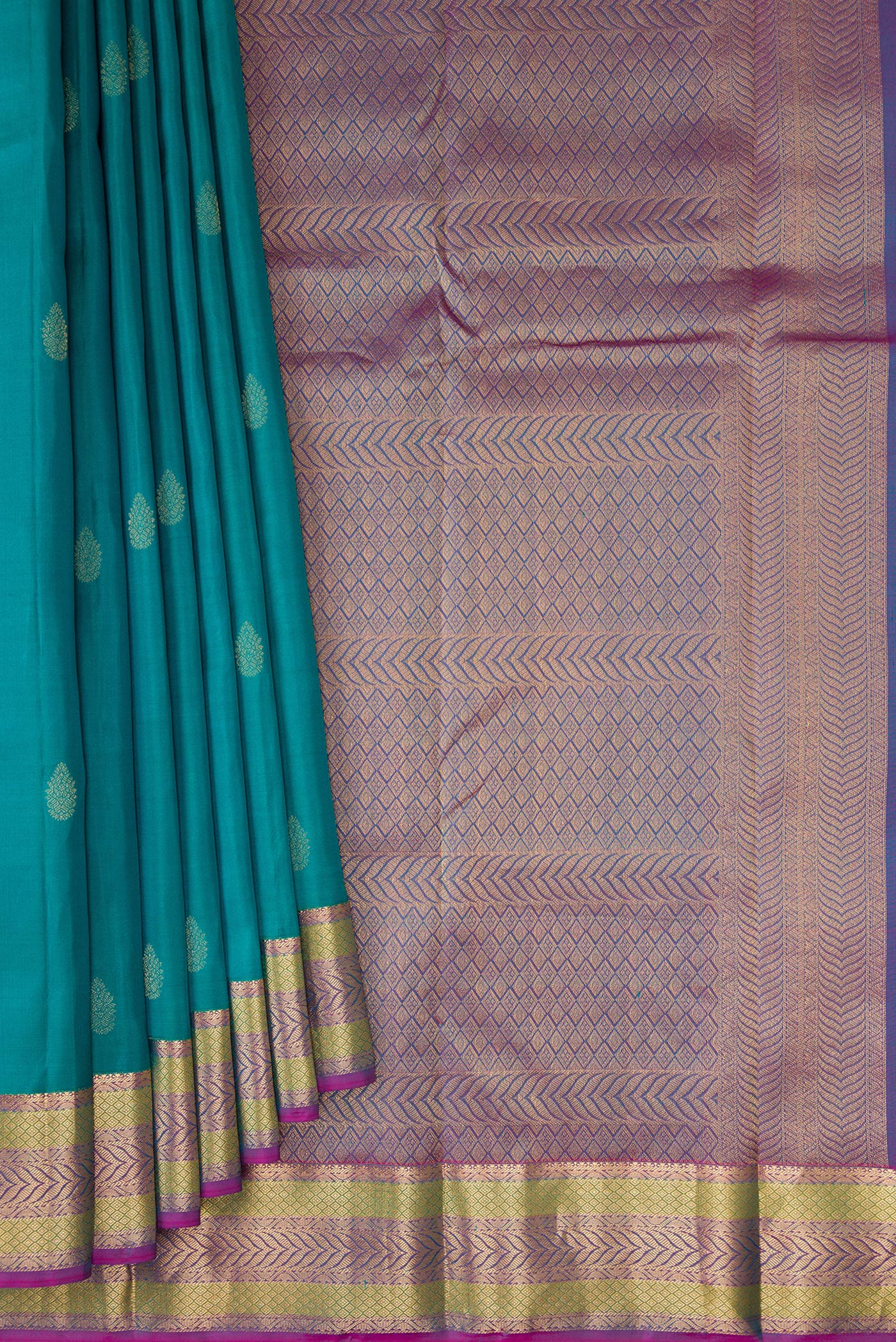 Pleats and pallu of Teal Kanchipuram Silk Saree with Zari Butta on the body and Zari Border. 