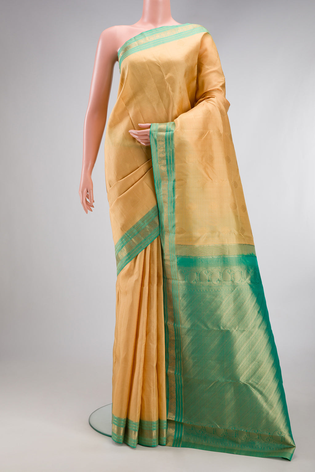 Sandal Kanchipuram Silk Saree with Zari Butta on the body and Zari Border.  displayed on a mannequin