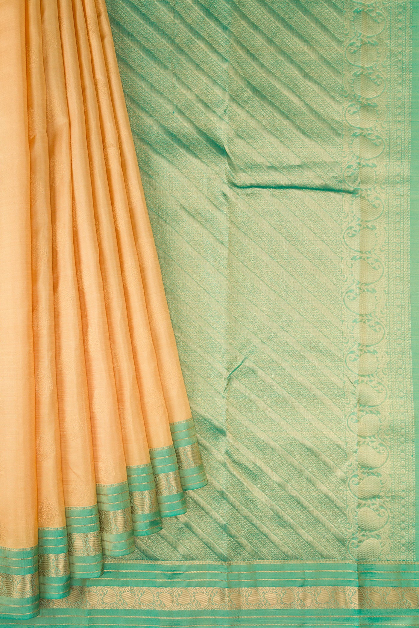 Pleats and pallu of Sandal Kanchipuram Silk Saree with Zari Butta on the body and Zari Border. 