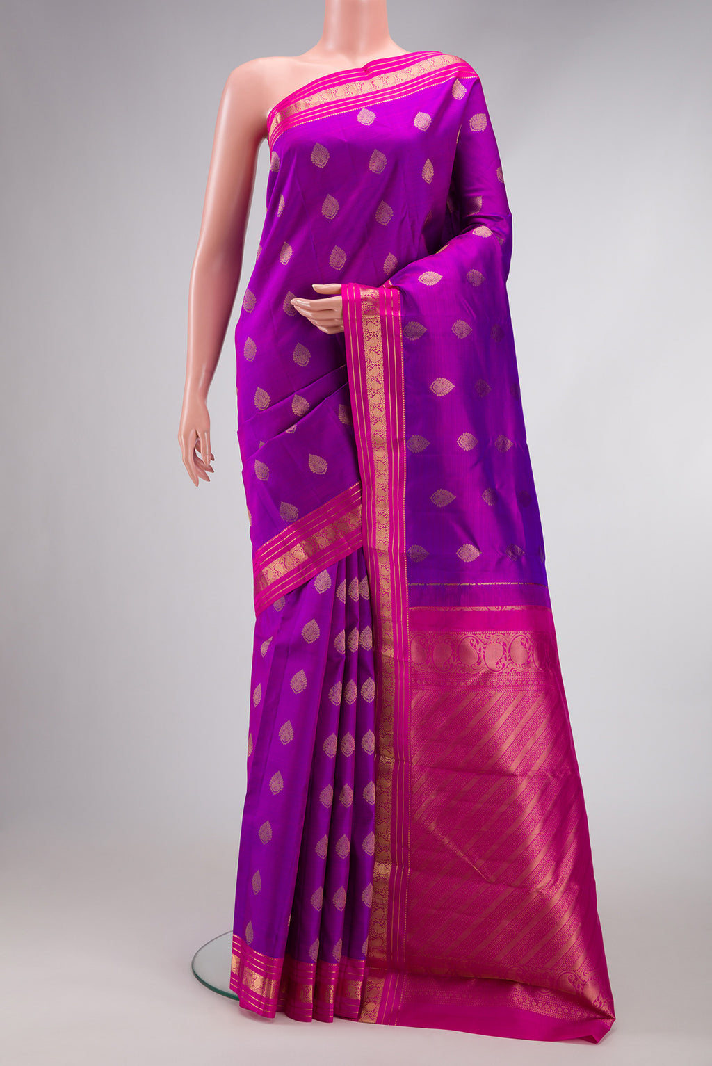 Purple Kanchipuram Silk Saree with Zari Butta on the body and Zari Border.  displayed on a mannequin