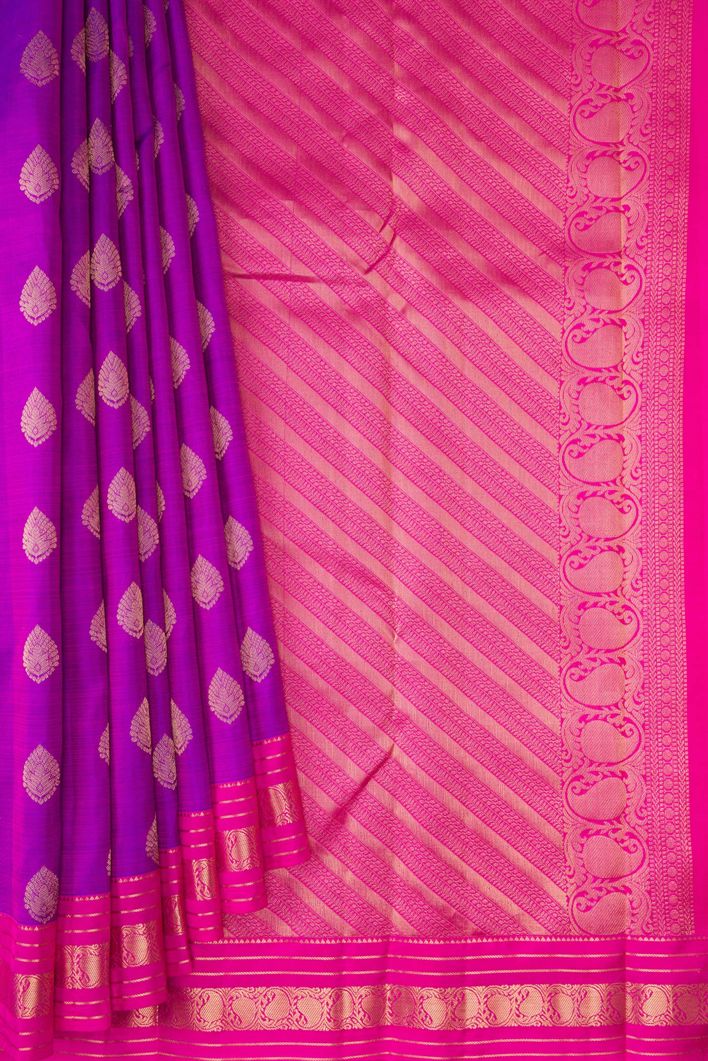 Pleats and pallu of Purple Kanchipuram Silk Saree with Zari Butta on the body and Zari Border. 