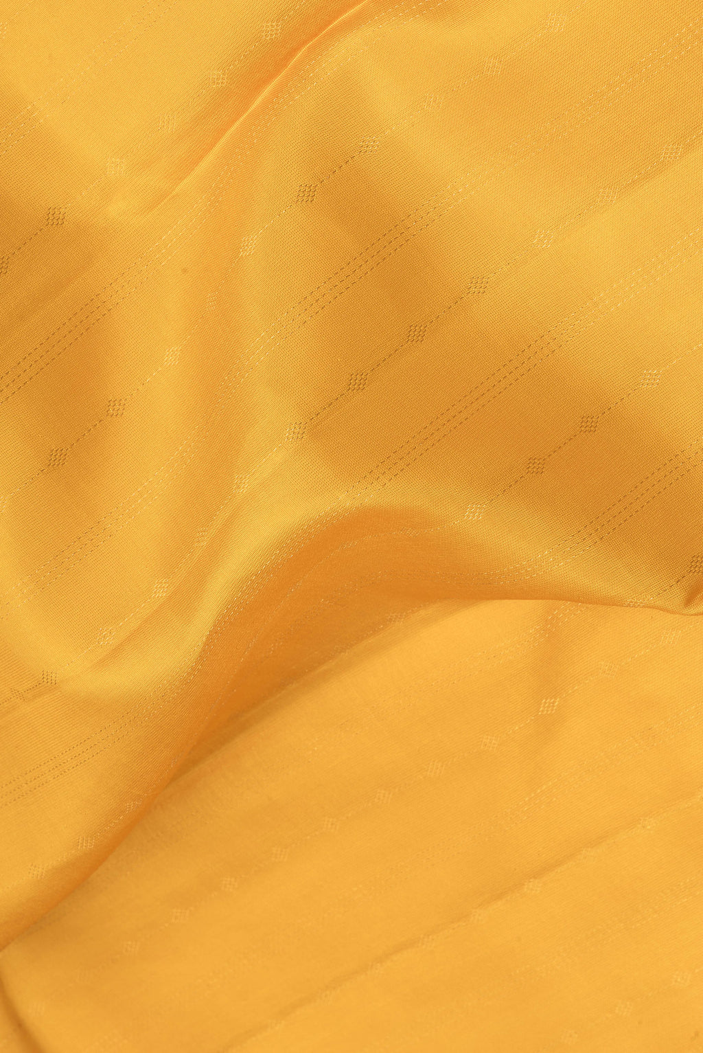 Close up of Mustard Kanchipuram Silk Saree with Stripes on the body and Zari Border.  displaying folds