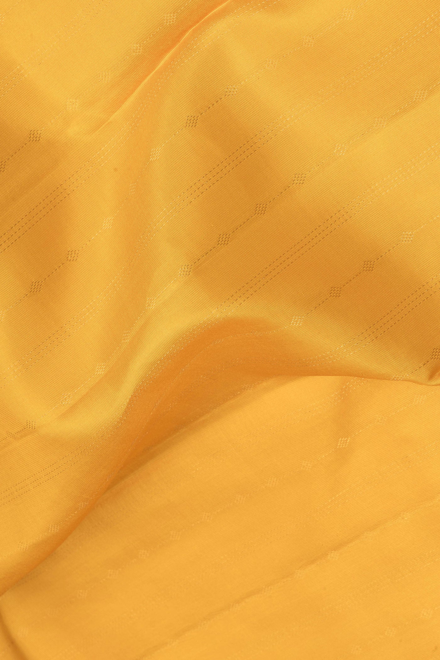 Close up of Mustard Kanchipuram Silk Saree with Stripes on the body and Zari Border.  displaying folds