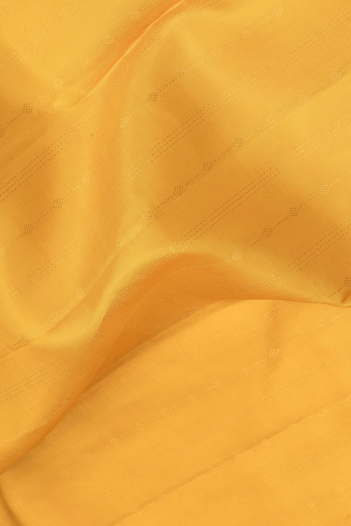 Close up of Mustard Kanchipuram Silk Saree with Stripes on the body and Zari Border.  displaying folds