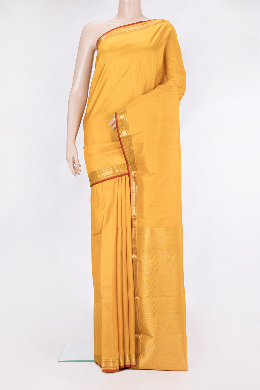 Mustard Kanchipuram Silk Saree with Stripes on the body and Zari Border.  displayed on a mannequin