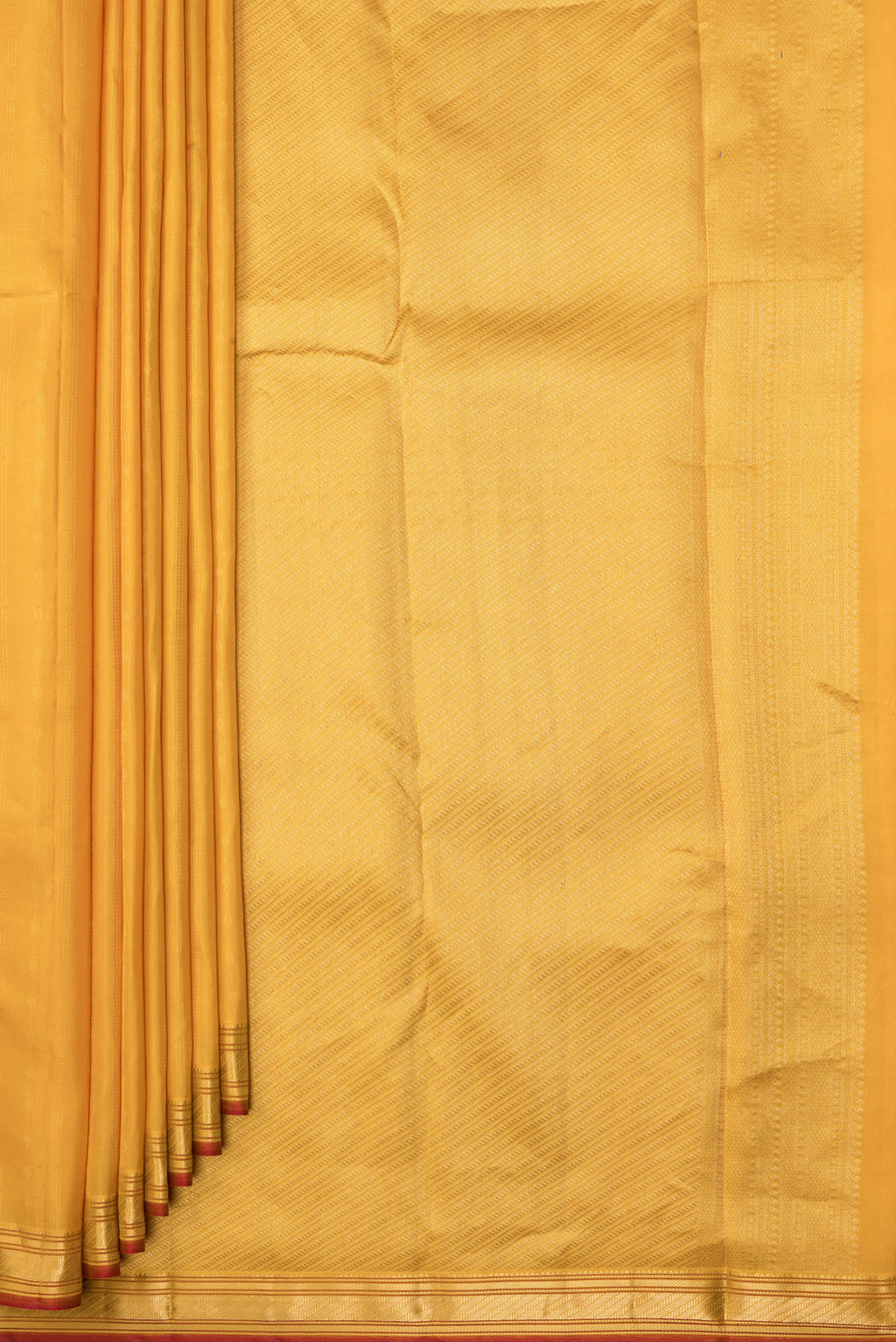 Pleats and pallu of Mustard Kanchipuram Silk Saree with Stripes on the body and Zari Border. 