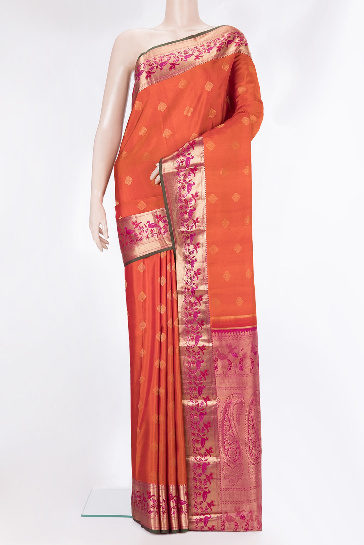 Pure Silk Orange Kanjivaram Saree with Zari Butta on the body and Zari Border.  displayed on a mannequin