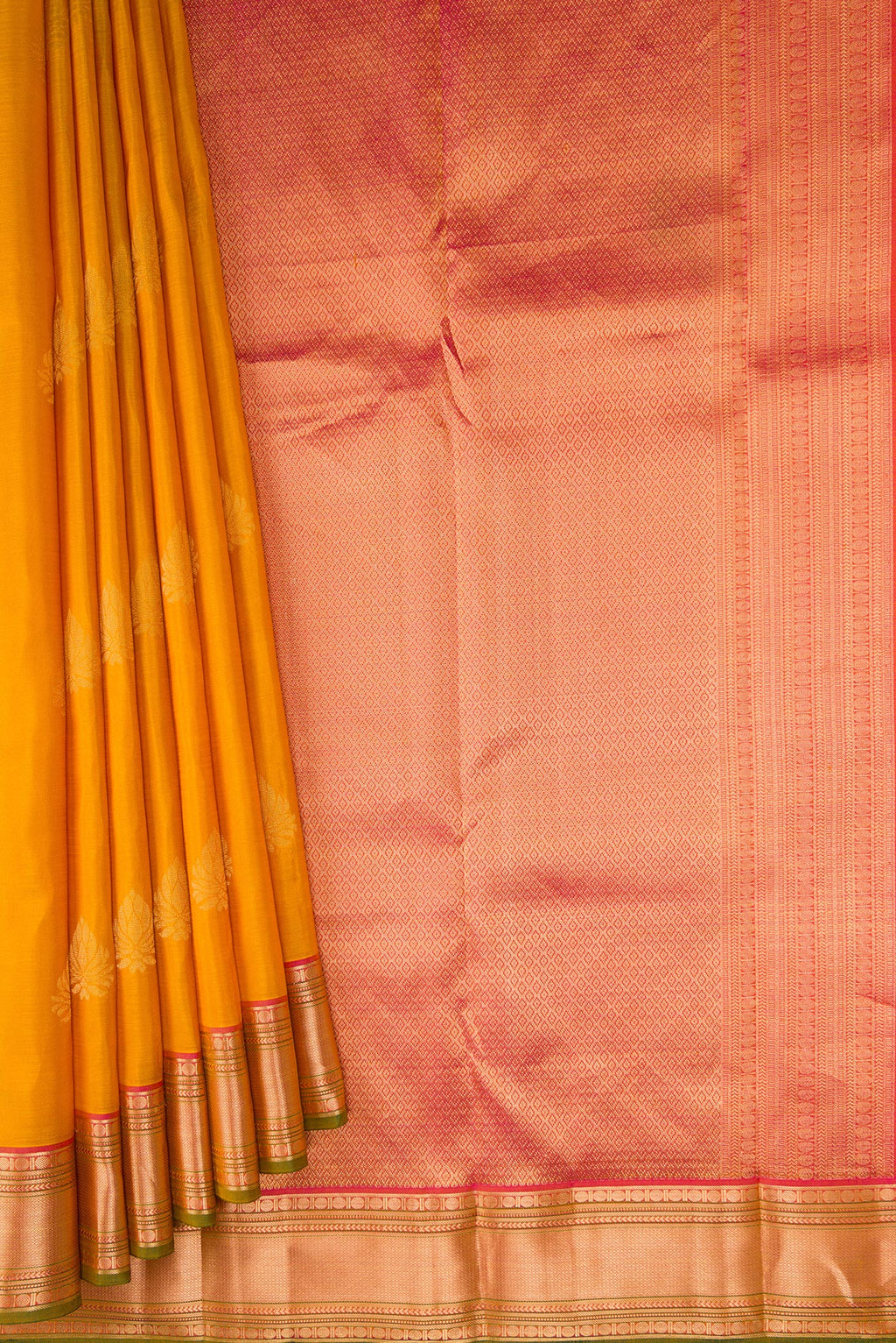 Pleats and pallu of Mustard Kanchipuram Silk Saree with Zari Butta on the body and Zari Border. 