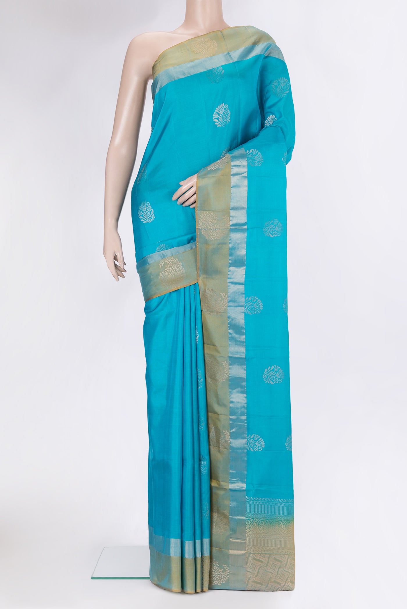 Sky Blue Soft Silk Saree with Zari Butta on the body and Fancy Border.  displayed on a mannequin