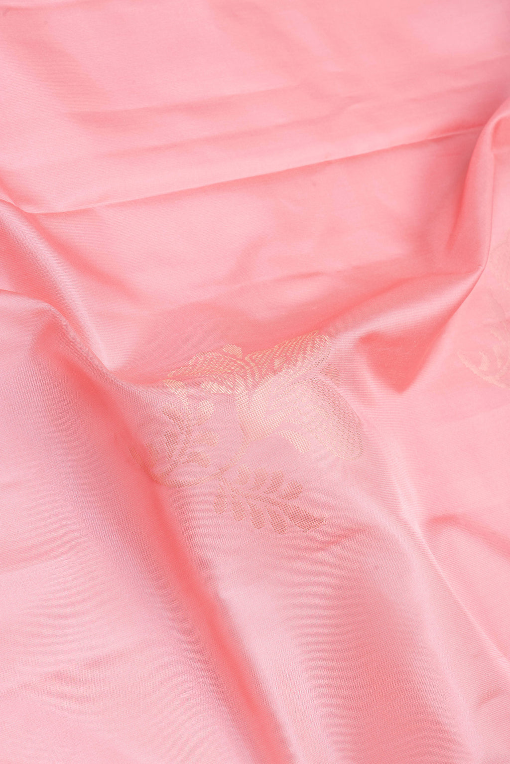 Close up of Rose pink Soft Silk Saree with Zari Butta on the body and Fancy Border.  displaying folds
