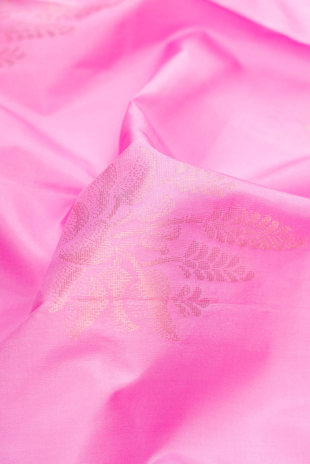 Close up of Pink Soft Silk Saree with Zari Butta on the body and Fancy Border.  displaying folds
