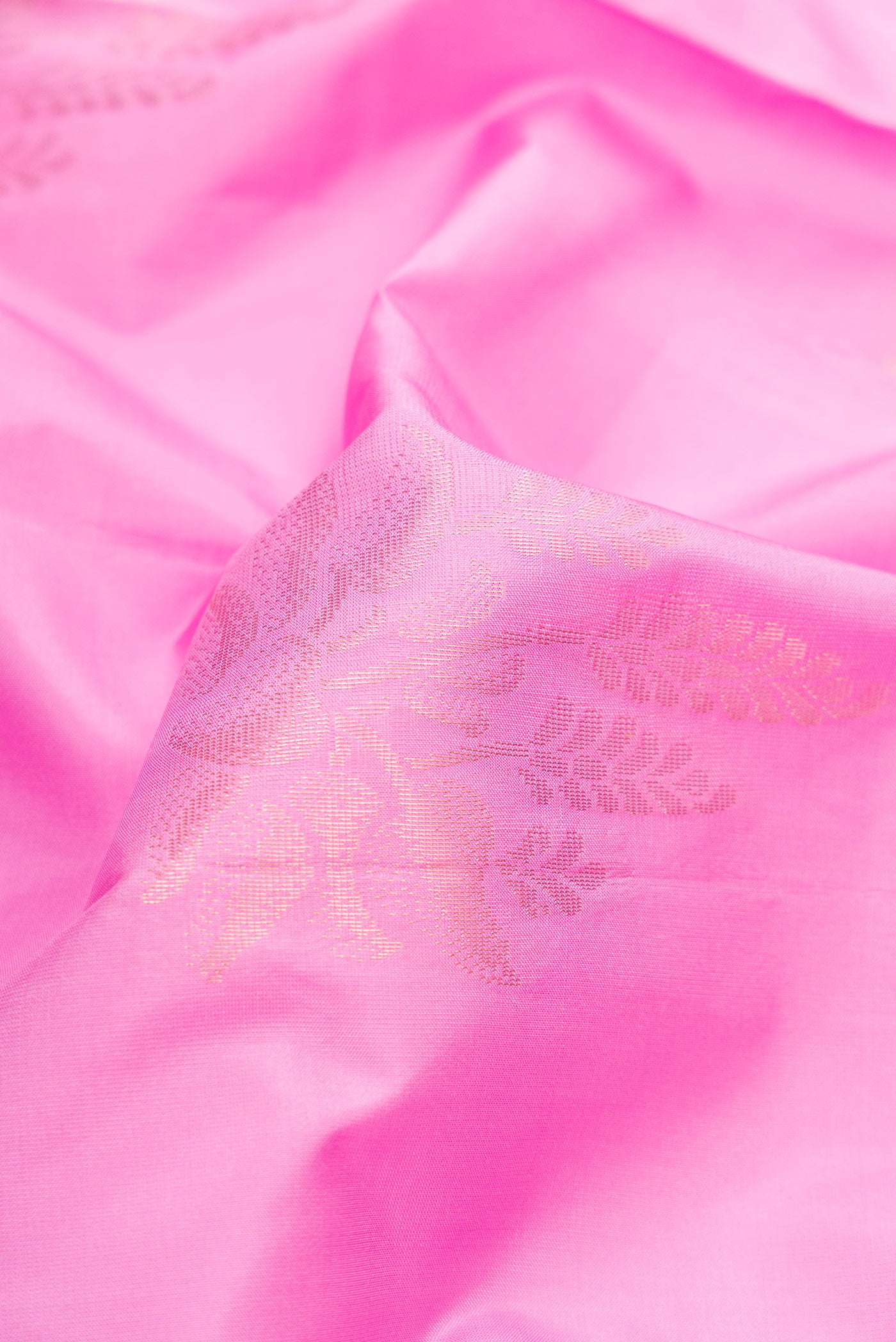 Close up of Pink Soft Silk Saree with Zari Butta on the body and Fancy Border.  displaying folds