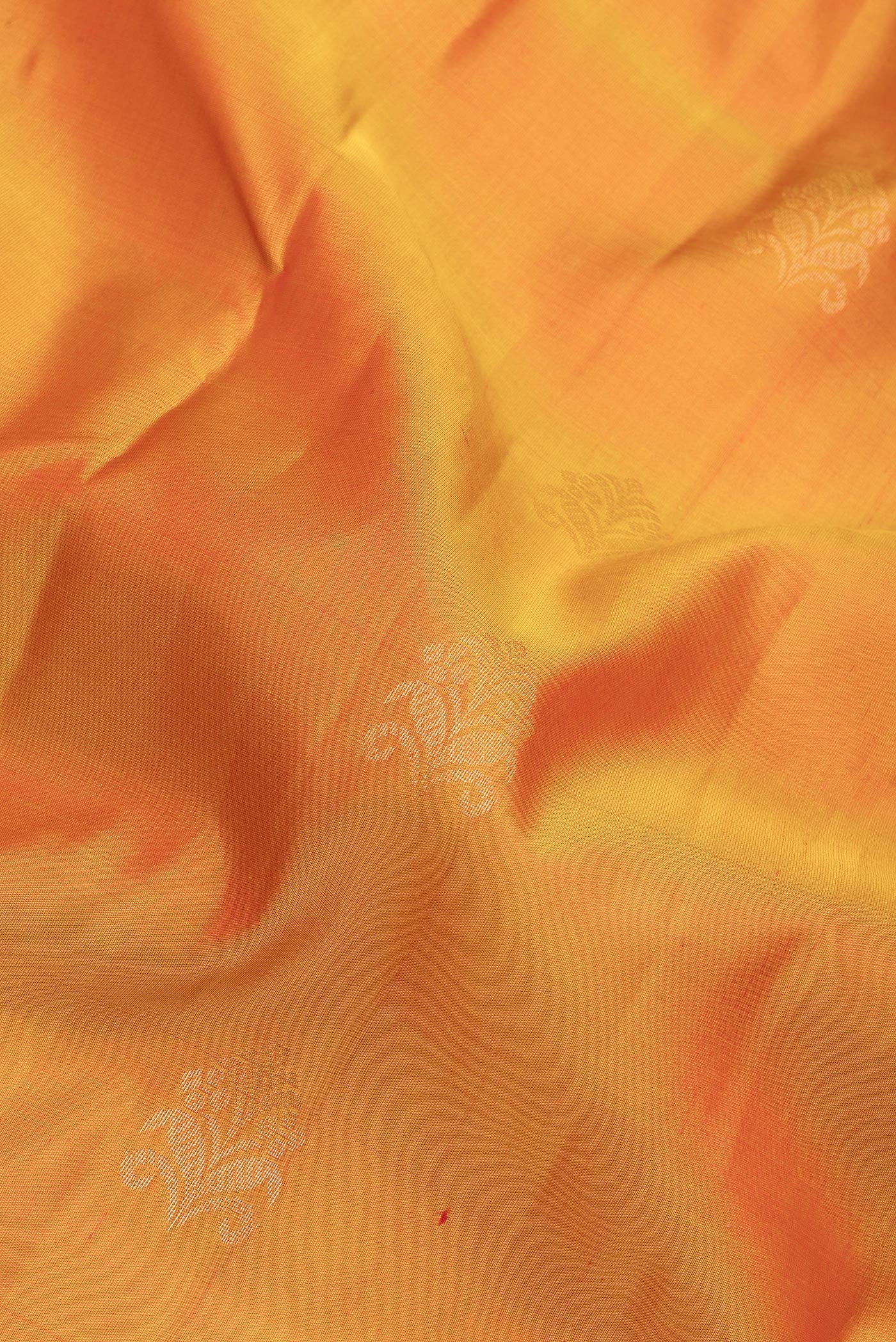 Close up of Mustard Soft Silk Saree with Zari Butta on the body and Fancy Border.  displaying folds