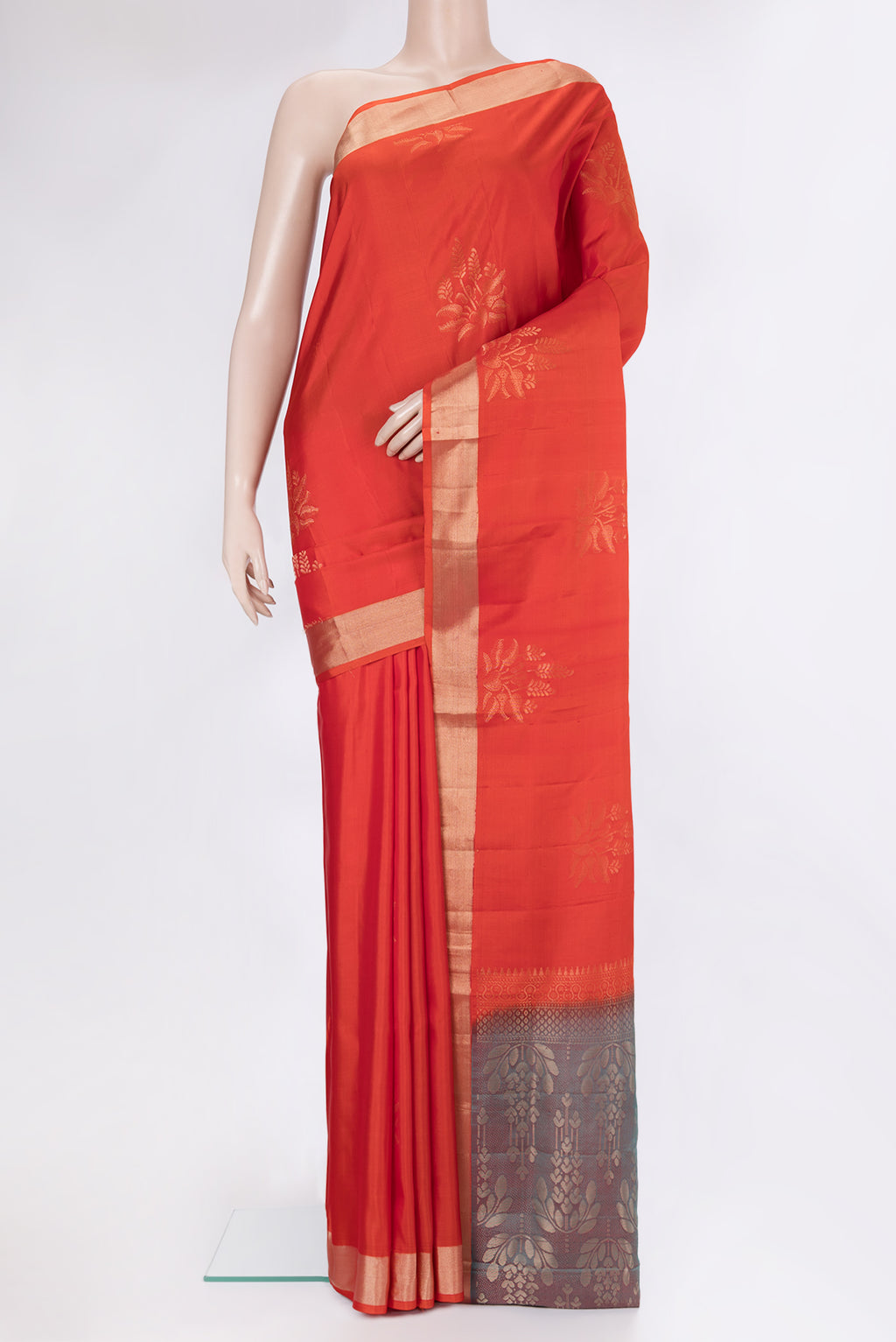Orange Soft Silk Saree with Zari Butta on the body and Zari Border.  displayed on a mannequin