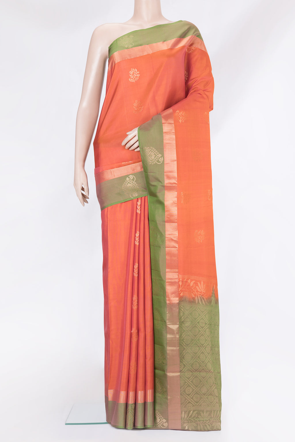 Orange Soft Silk Saree with Zari Butta on the body and Fancy Border.  displayed on a mannequin