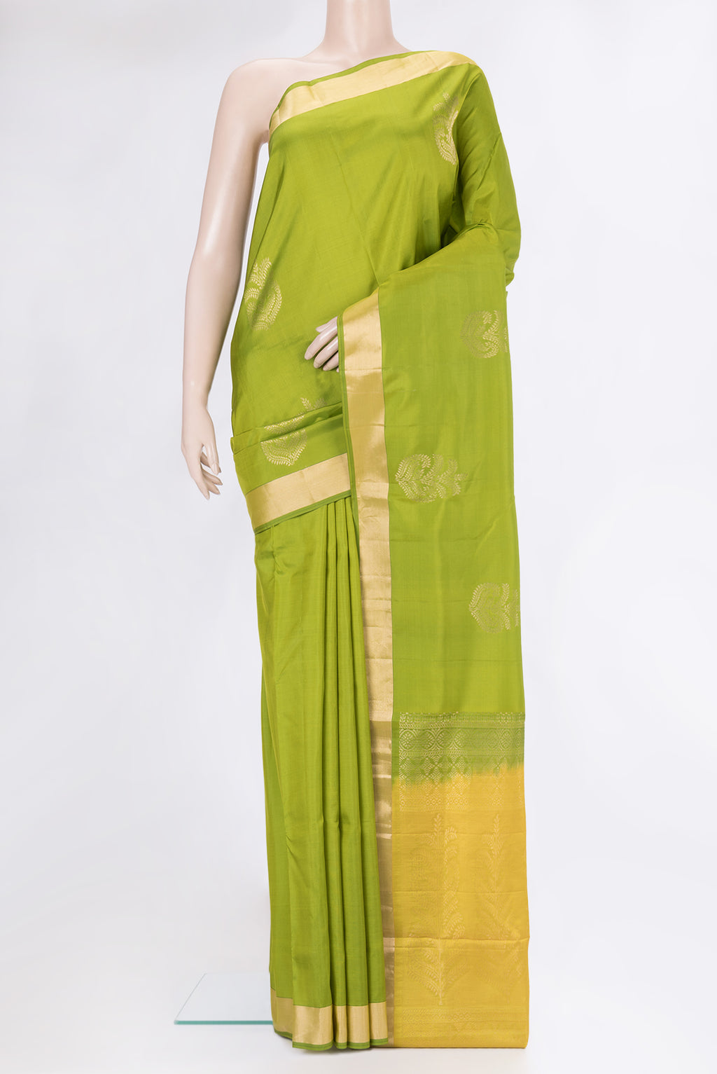 Parrot Green Soft Silk Saree with Zari Butta on the body and Zari Border.  displayed on a mannequin