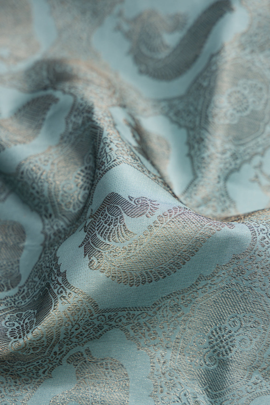 Close up of Grey Dual Tone Kanjivaram Silk Saree with Jacquard design on the body and Fancy Border.  displaying folds