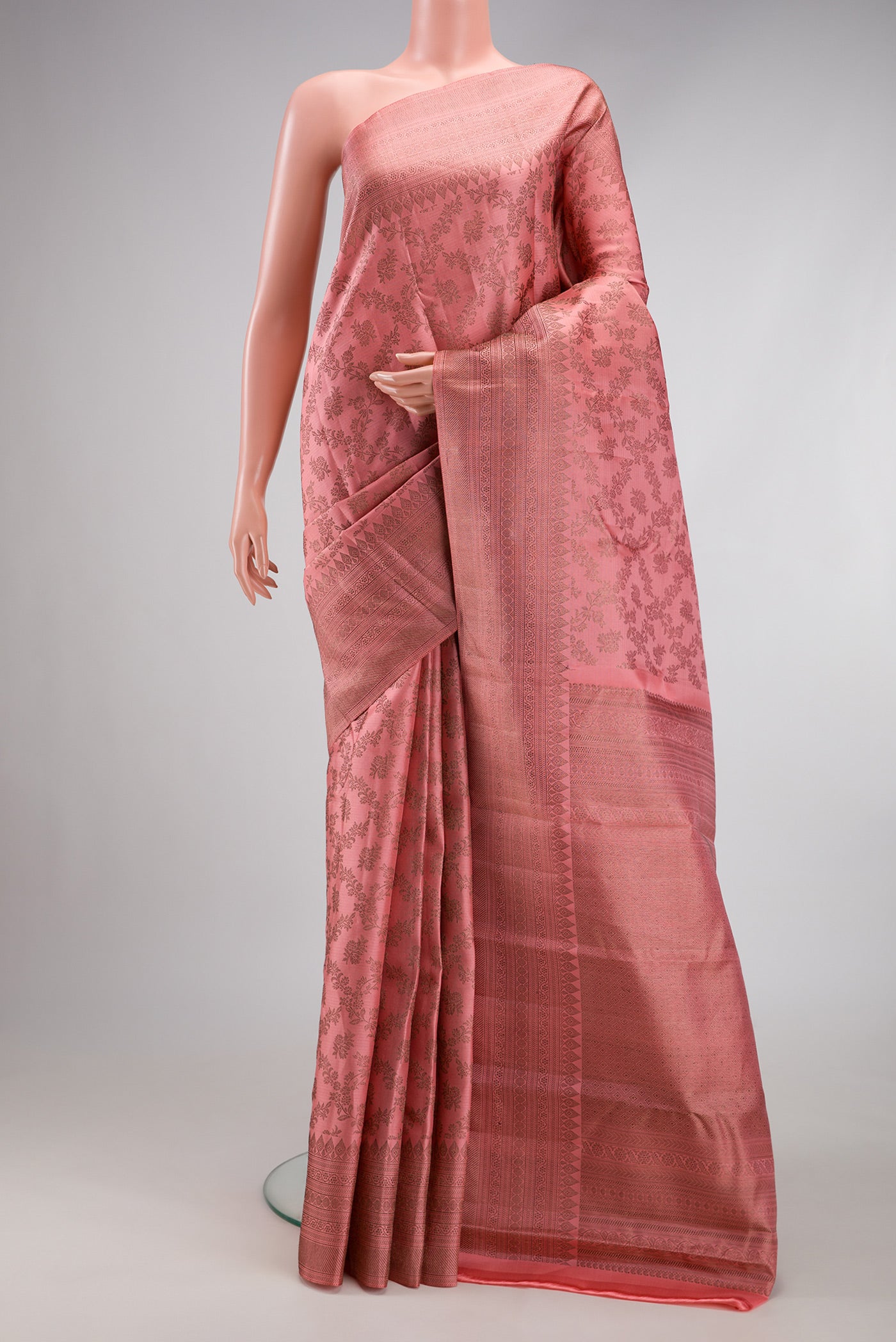 Peach Kanjivaram Silk Saree with Zari Brocade on the body and Fancy Border.  displayed on a mannequin