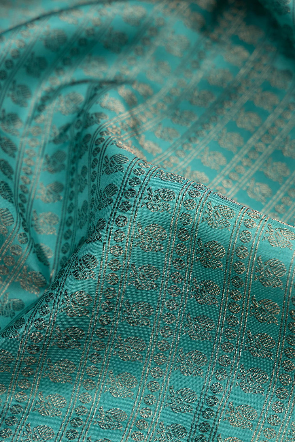 Close up of Maya Blue Kanjivaram Silk Saree with Jacquard design on the body and Fancy Border.  displaying folds