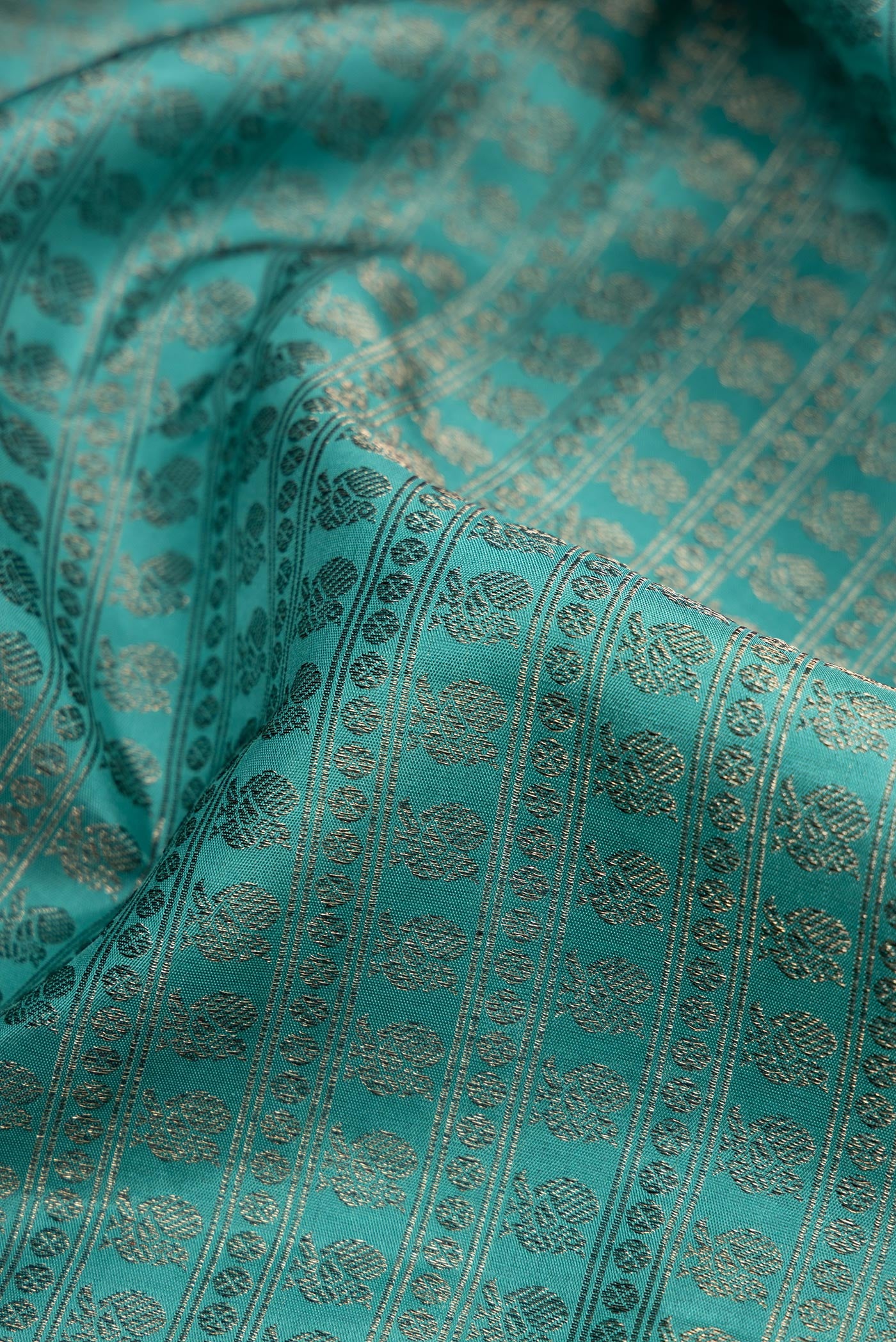 Close up of Maya Blue Kanjivaram Silk Saree with Jacquard design on the body and Fancy Border.  displaying folds