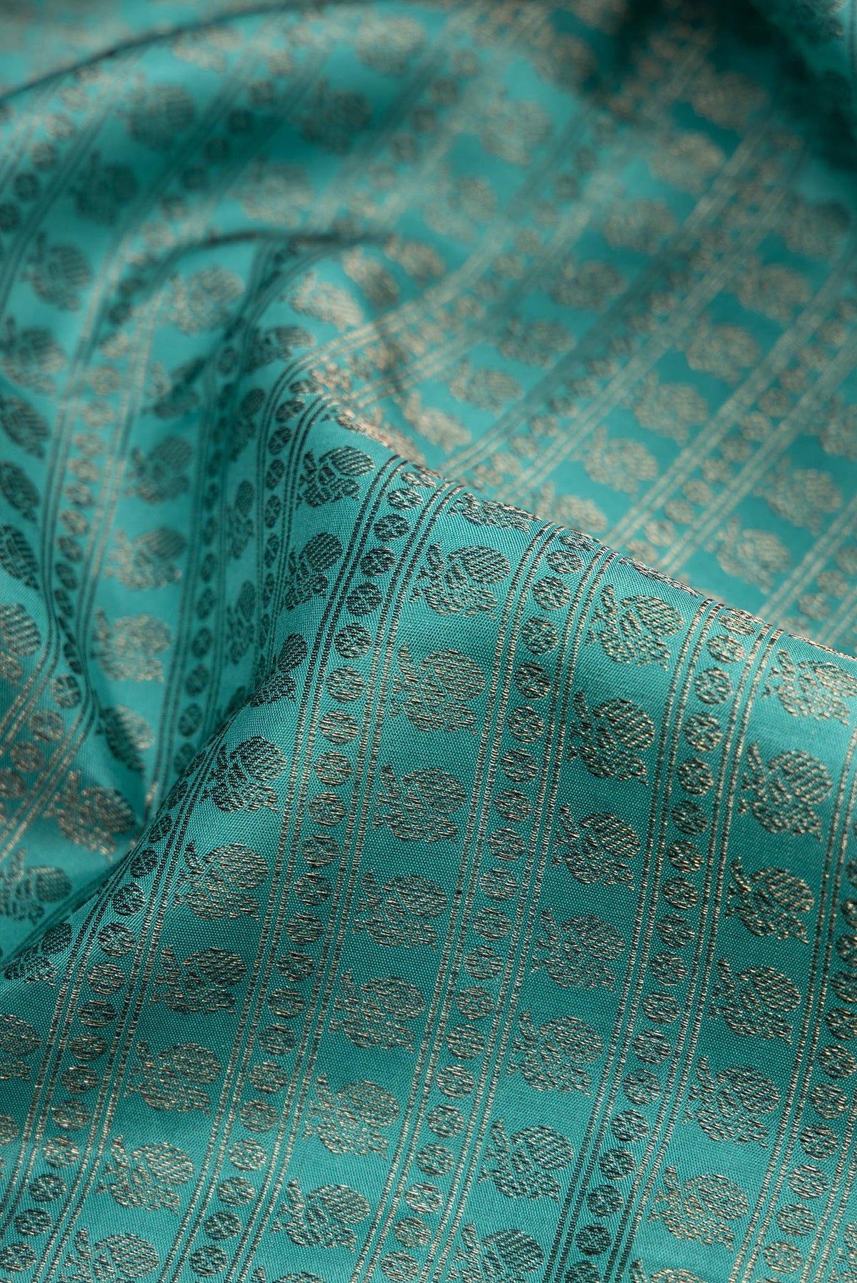 Close up of Maya Blue Kanjivaram Silk Saree with Jacquard design on the body and Fancy Border.  displaying folds