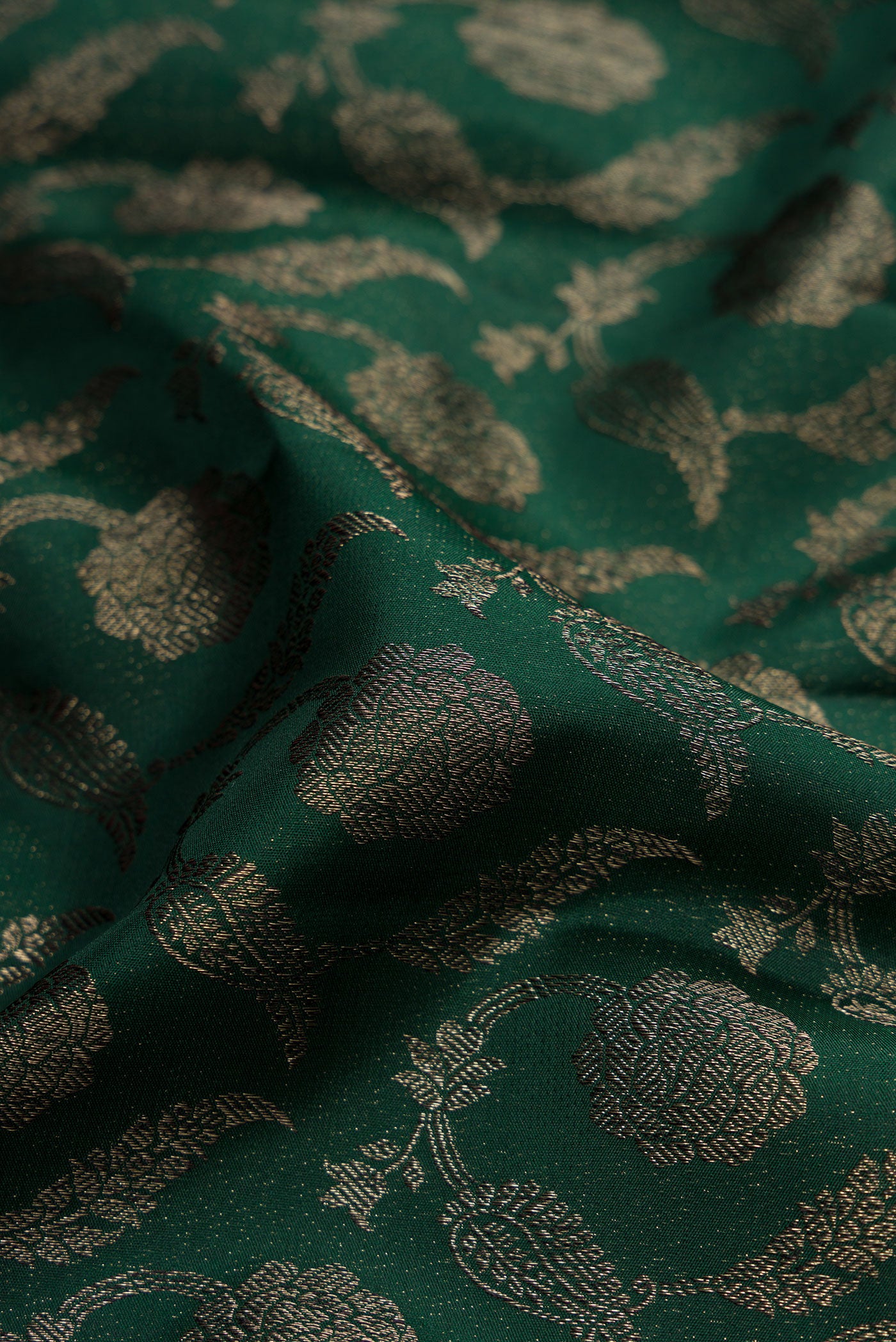 Close up of Bottle Green Dual Tone Kanjivaram Silk Saree with Jacquard design on the body and Fancy Border.  displaying folds