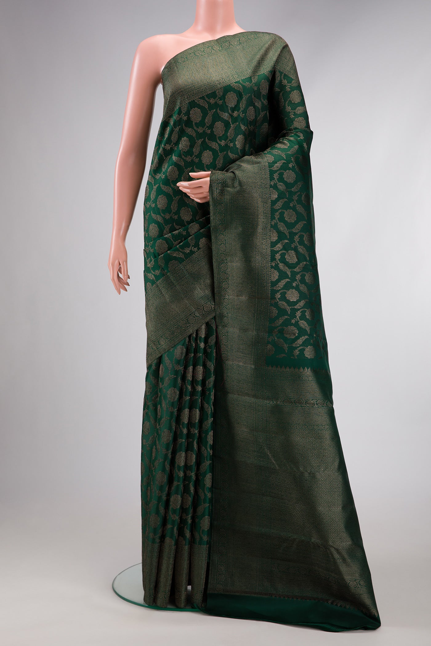 Bottle Green Dual Tone Kanjivaram Silk Saree with Jacquard design on the body and Fancy Border.  displayed on a mannequin