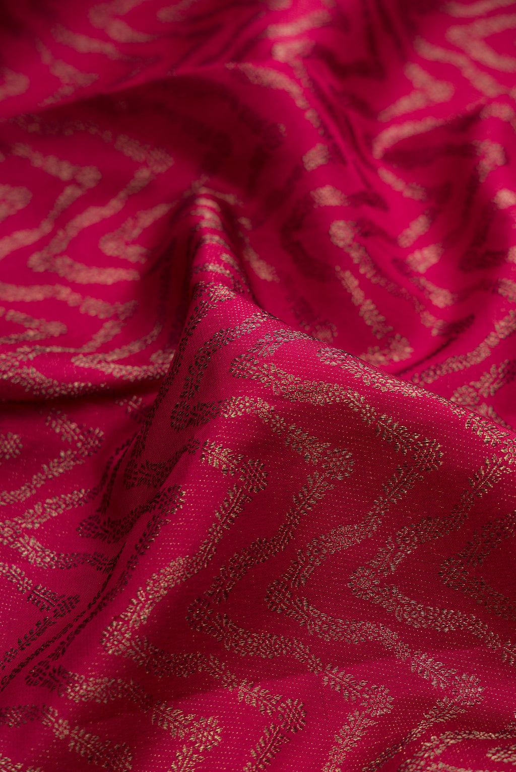 Close up of Pure Silk Maroon Kanjivaram Saree with Zari Brocade on the body and Fancy Border.  displaying folds