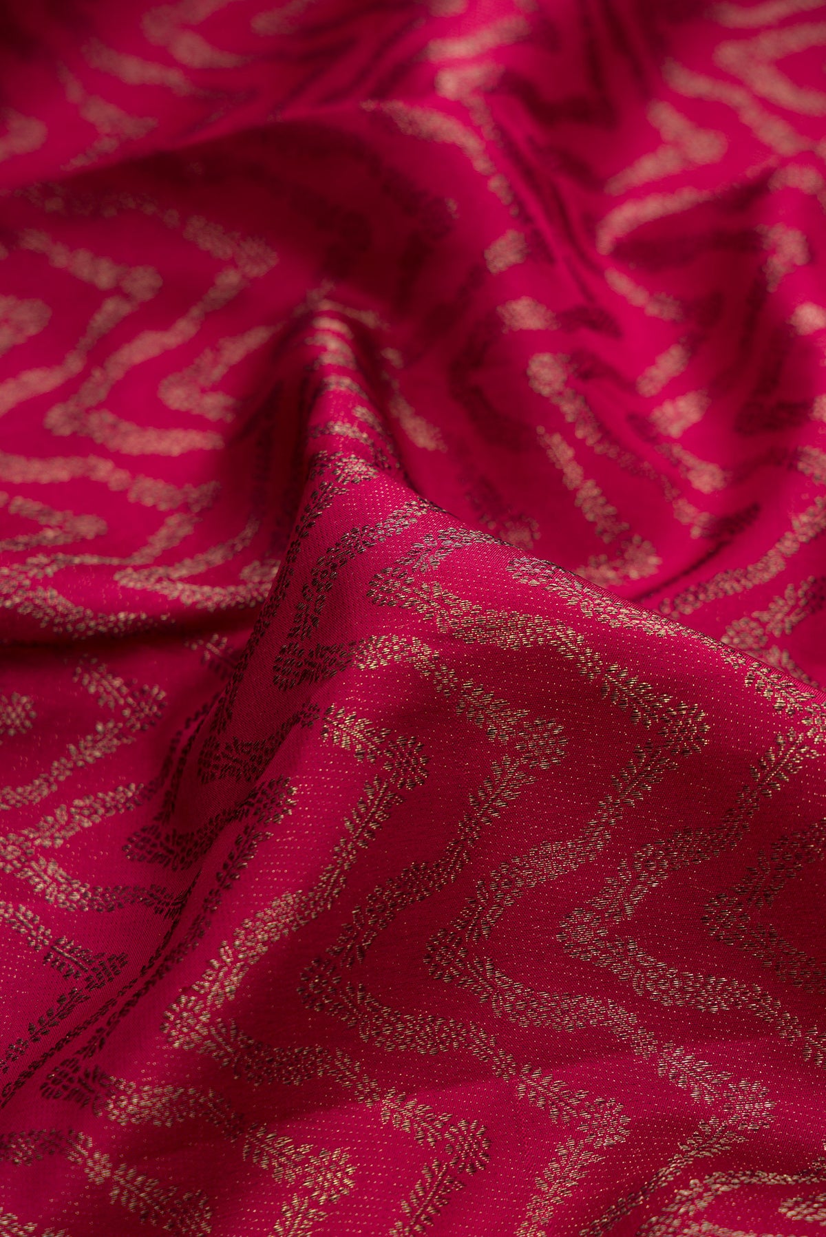 Close up of Pure Silk Maroon Kanjivaram Saree with Zari Brocade on the body and Fancy Border.  displaying folds