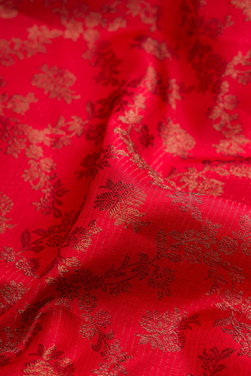 Close up of Red Dual Tone Kanjivaram Silk Saree with Jacquard design on the body and Fancy Border.  displaying folds