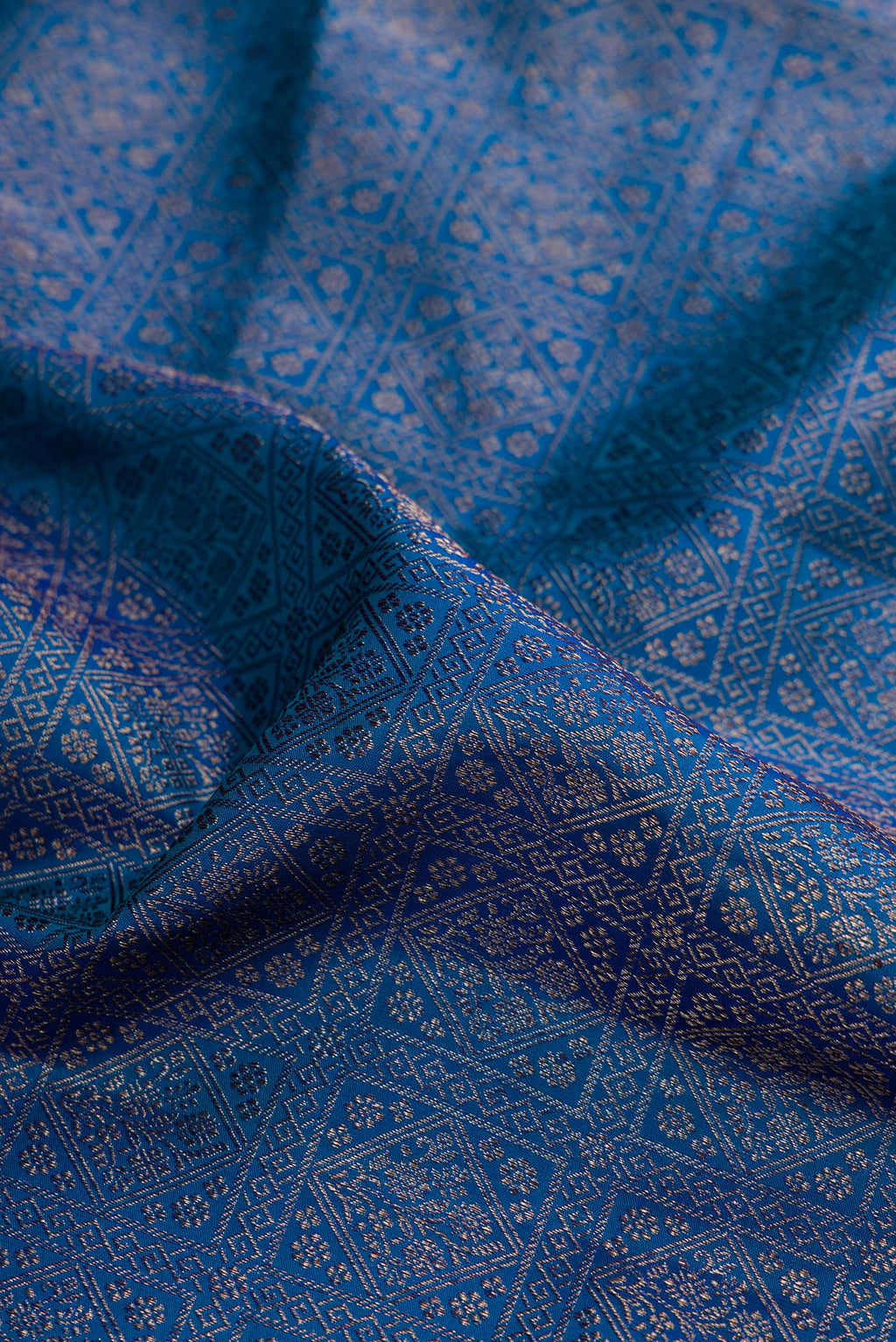 Close up of Peacock Blue Dual Tone Kanjivaram Silk Saree with Zari Brocade on the body and Fancy Border.  displaying folds