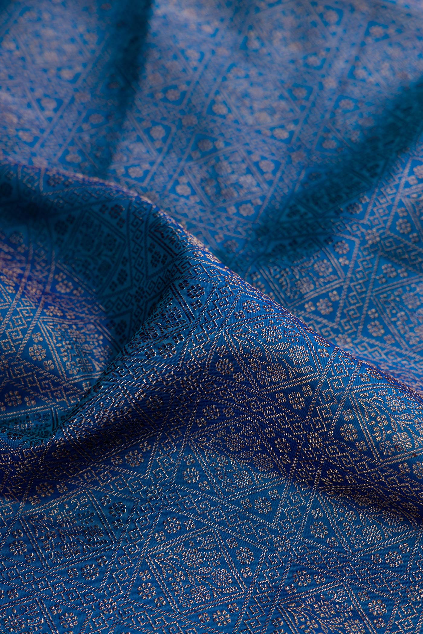 Close up of Peacock Blue Dual Tone Kanjivaram Silk Saree with Zari Brocade on the body and Fancy Border.  displaying folds