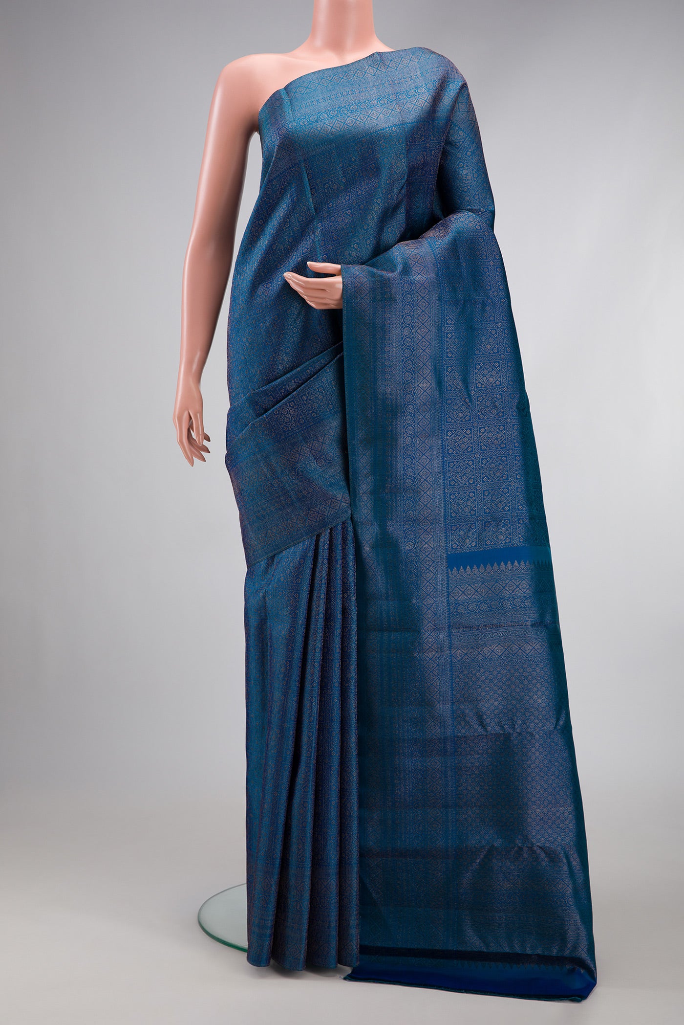 Peacock Blue Dual Tone Kanjivaram Silk Saree with Zari Brocade on the body and Fancy Border.  displayed on a mannequin