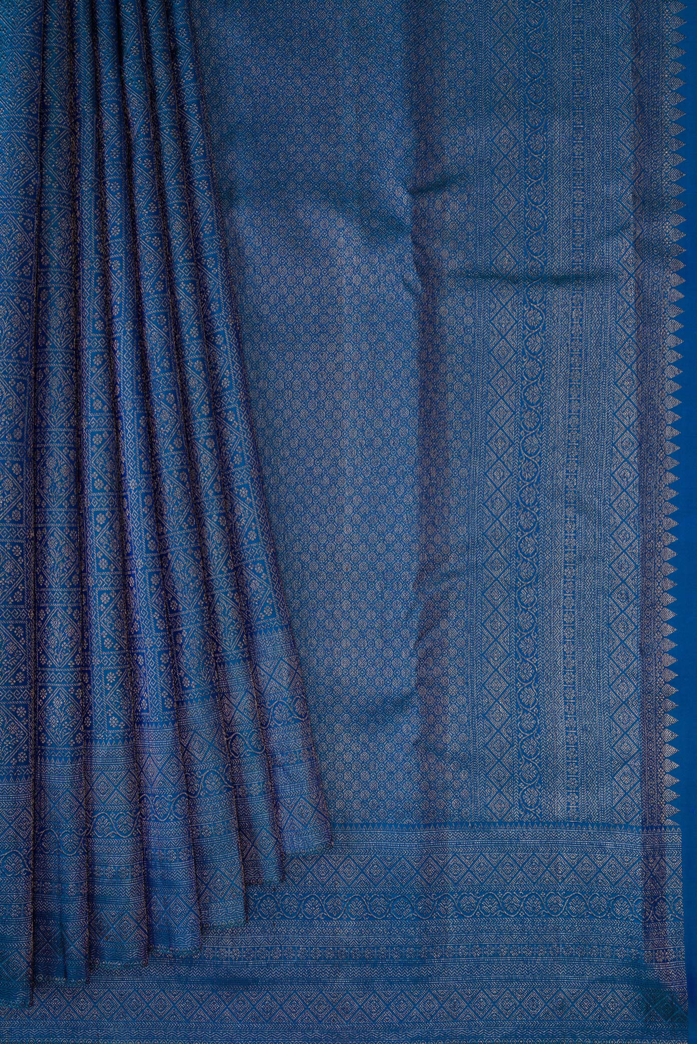 Pleats and pallu of Peacock Blue Dual Tone Kanjivaram Silk Saree with Zari Brocade on the body and Fancy Border. 