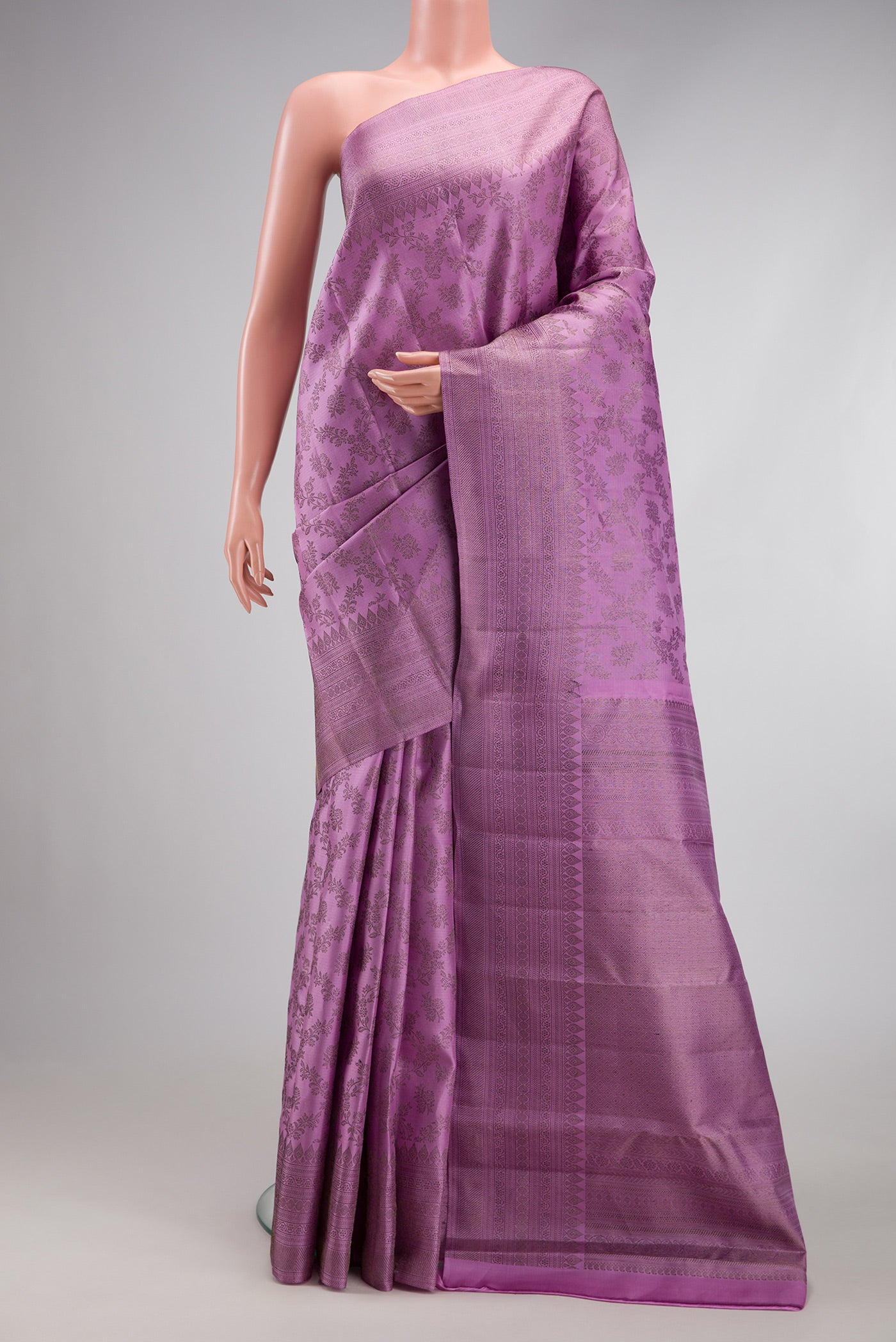 Lavender Kanjivaram Silk Saree with Zari Brocade on the body and Fancy Border.  displayed on a mannequin