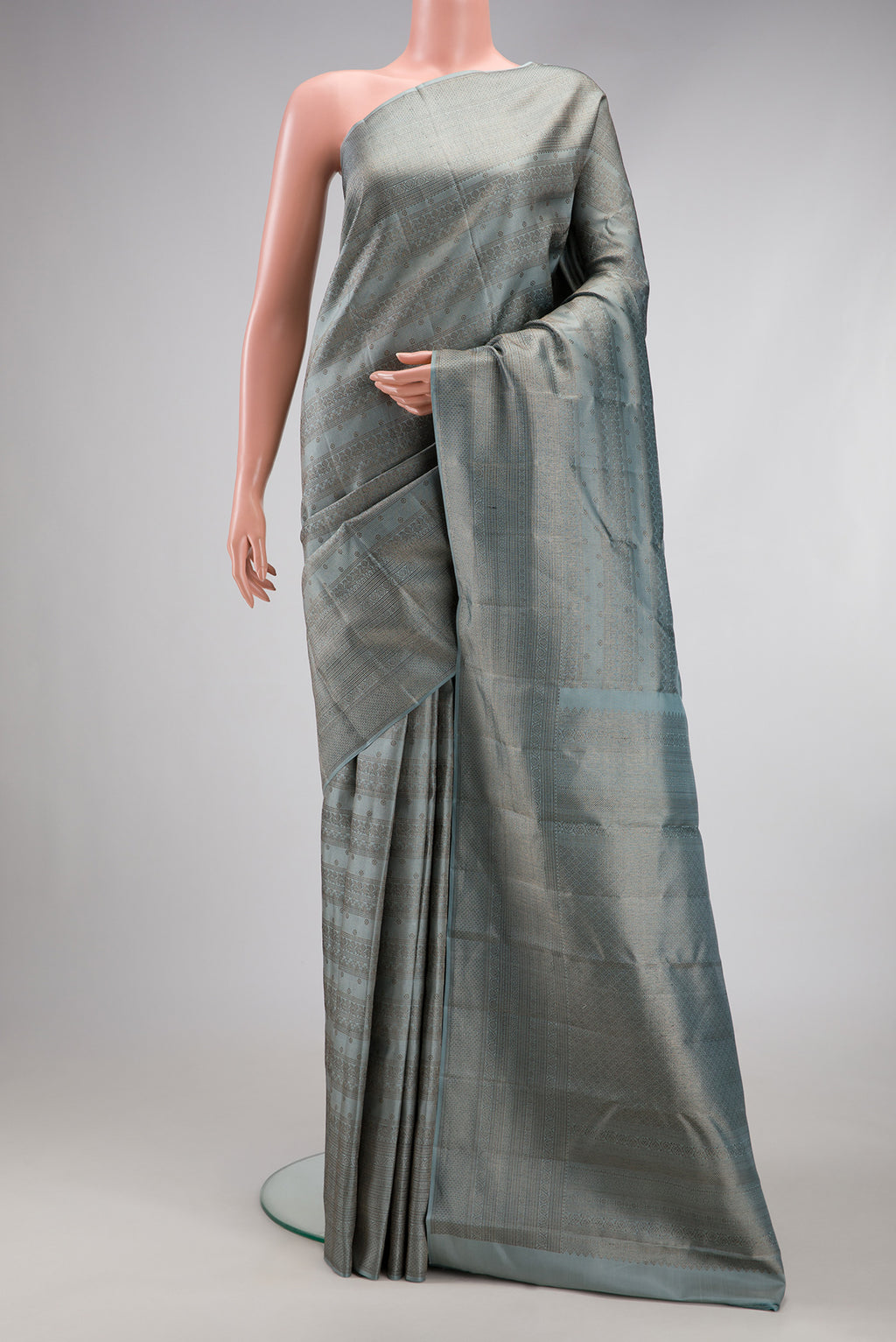 Grey Kanjivaram Silk Saree with Zari Brocade on the body and Fancy Border.  displayed on a mannequin