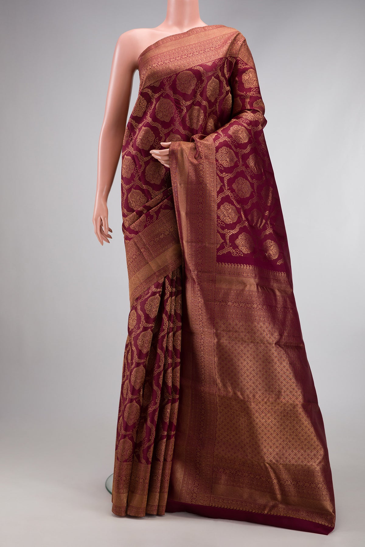 Maroon Kanjivaram Silk Saree with Zari Brocade on the body and Fancy Border.  displayed on a mannequin