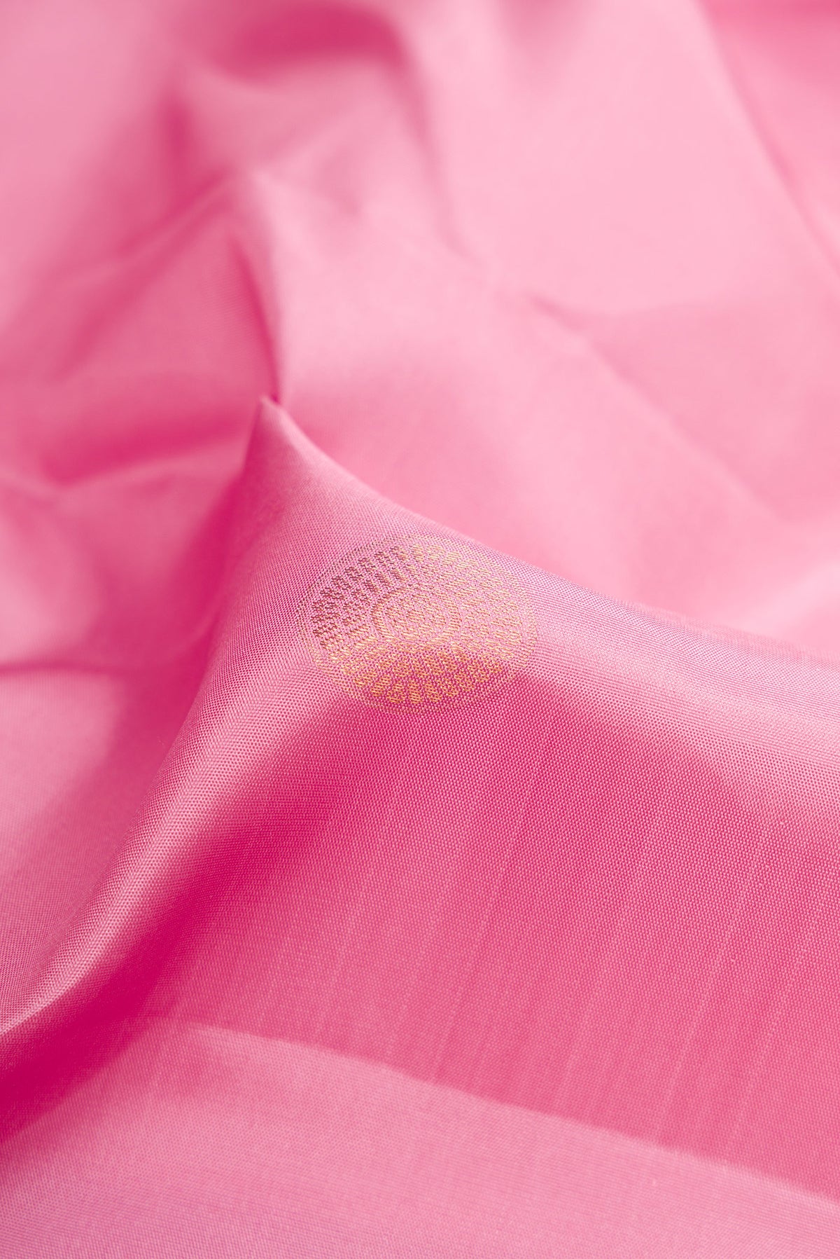 Close up of Rose pink Kanjivaram Silk Saree with Zari Butta on the body and Fancy Border.  displaying folds