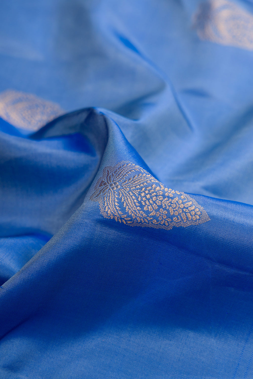 Close up of Blue Kanjivaram Silk Saree with Zari Butta on the body and Fancy Border.  displaying folds
