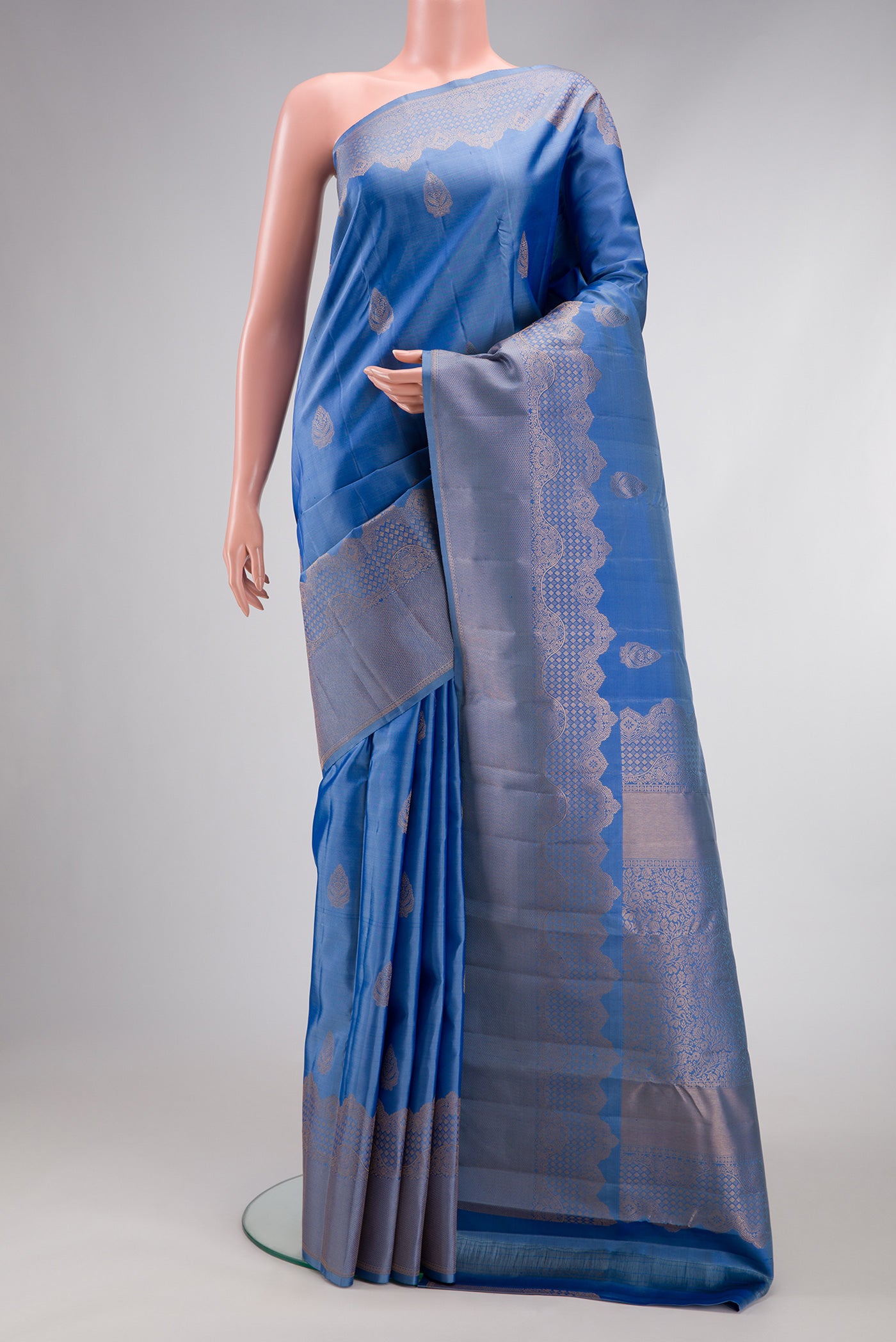 Blue Kanjivaram Silk Saree with Zari Butta on the body and Fancy Border.  displayed on a mannequin