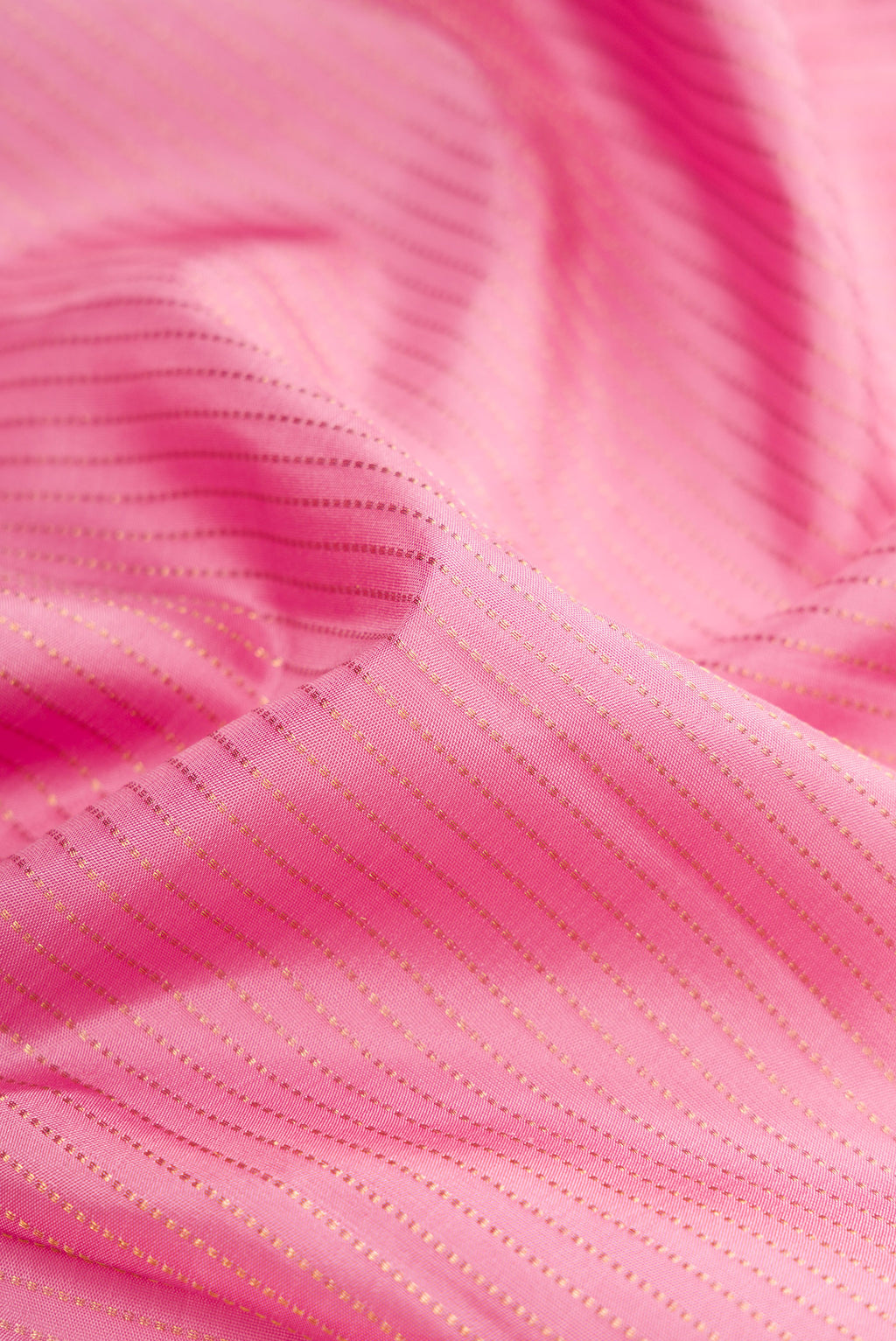 Close up of Pink Dual Tone Kanjivaram Silk Saree with Stripes on the body and Fancy Border.  displaying folds