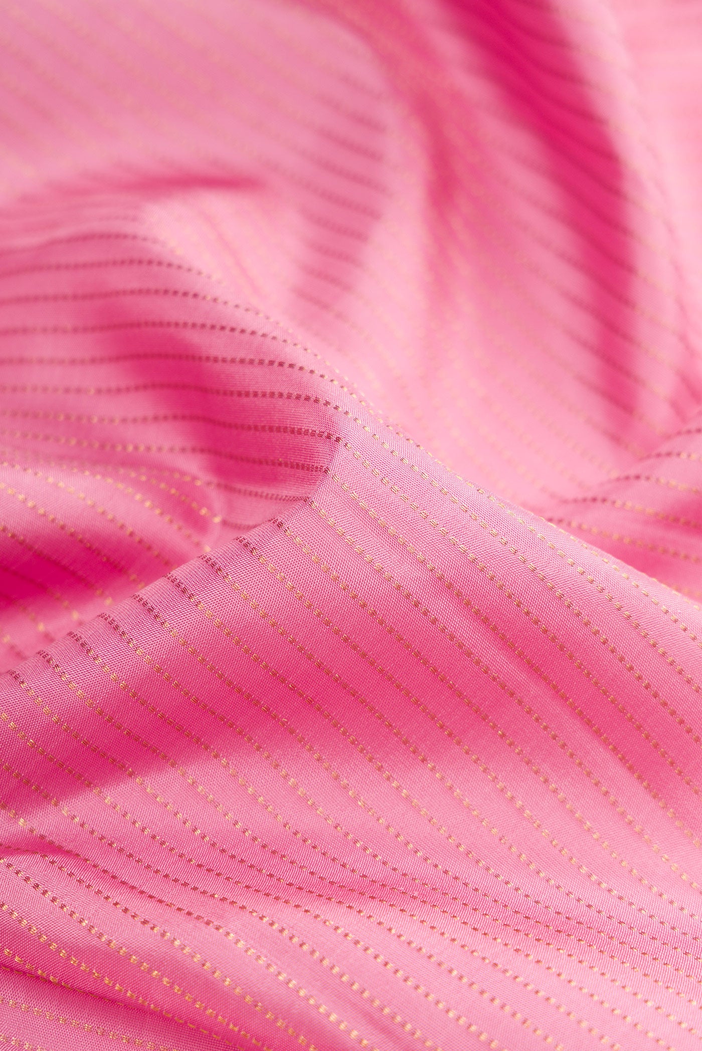 Close up of Pink Dual Tone Kanjivaram Silk Saree with Stripes on the body and Fancy Border.  displaying folds