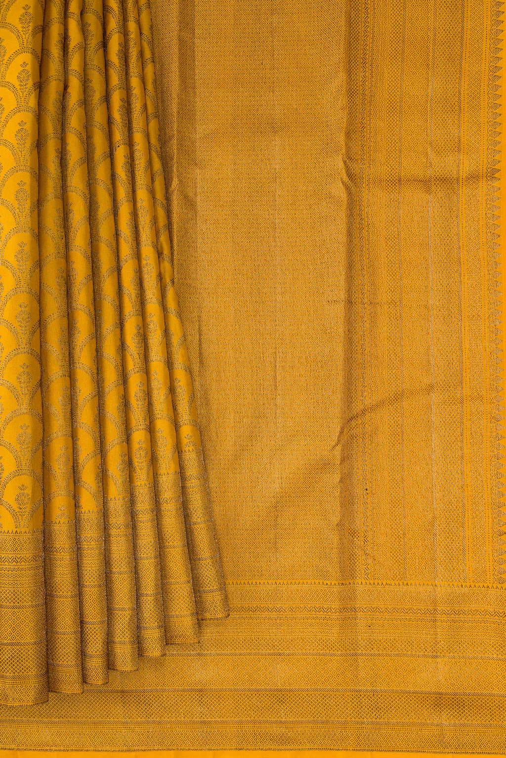 Pleats and pallu of Mustard Kanjivaram Silk Saree with Jacquard design on the body and Fancy Border. 