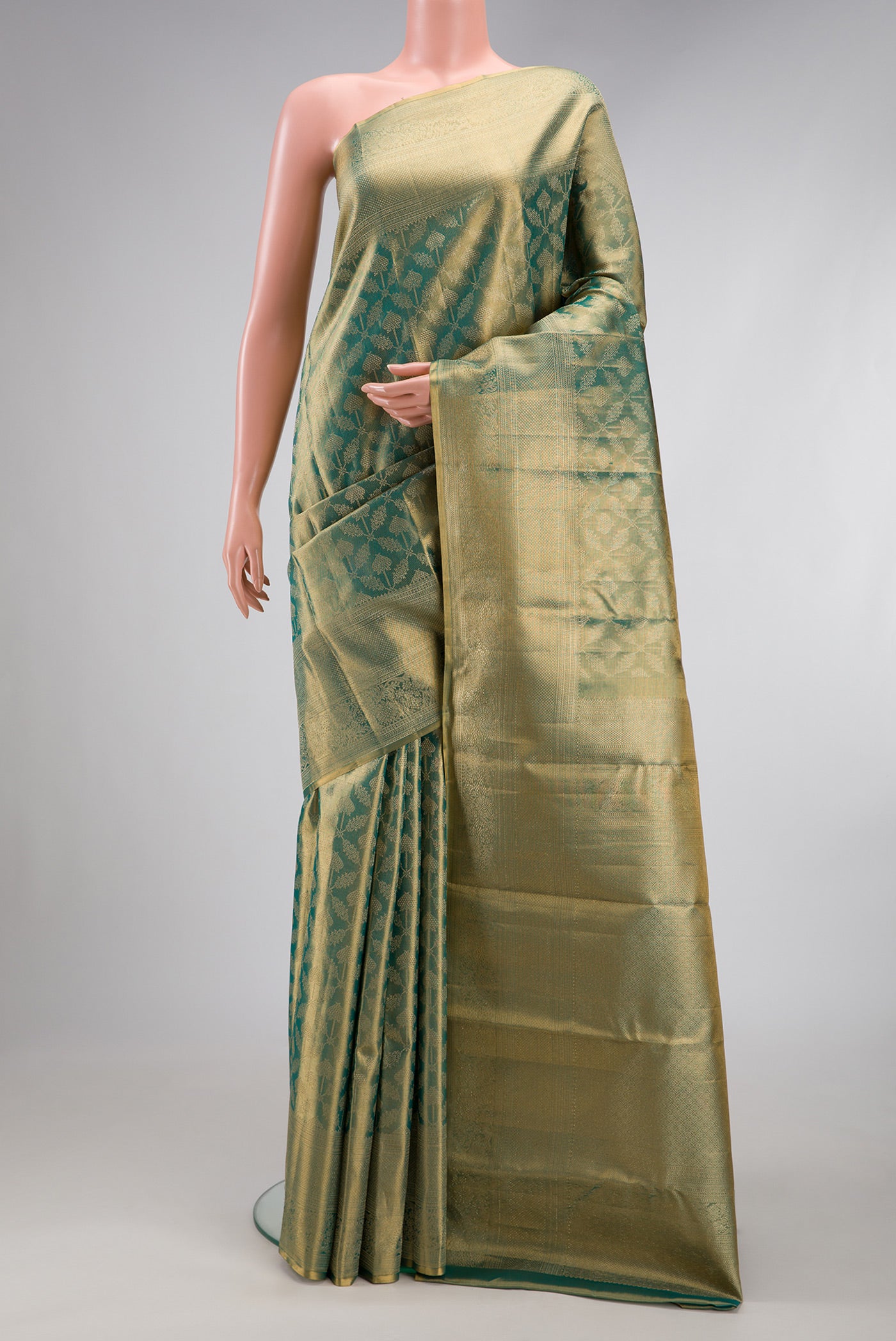 Green Dual Tone Kanjivaram Tissue Silk Saree with Zari Brocade on the body and Zari Border.  displayed on a mannequin